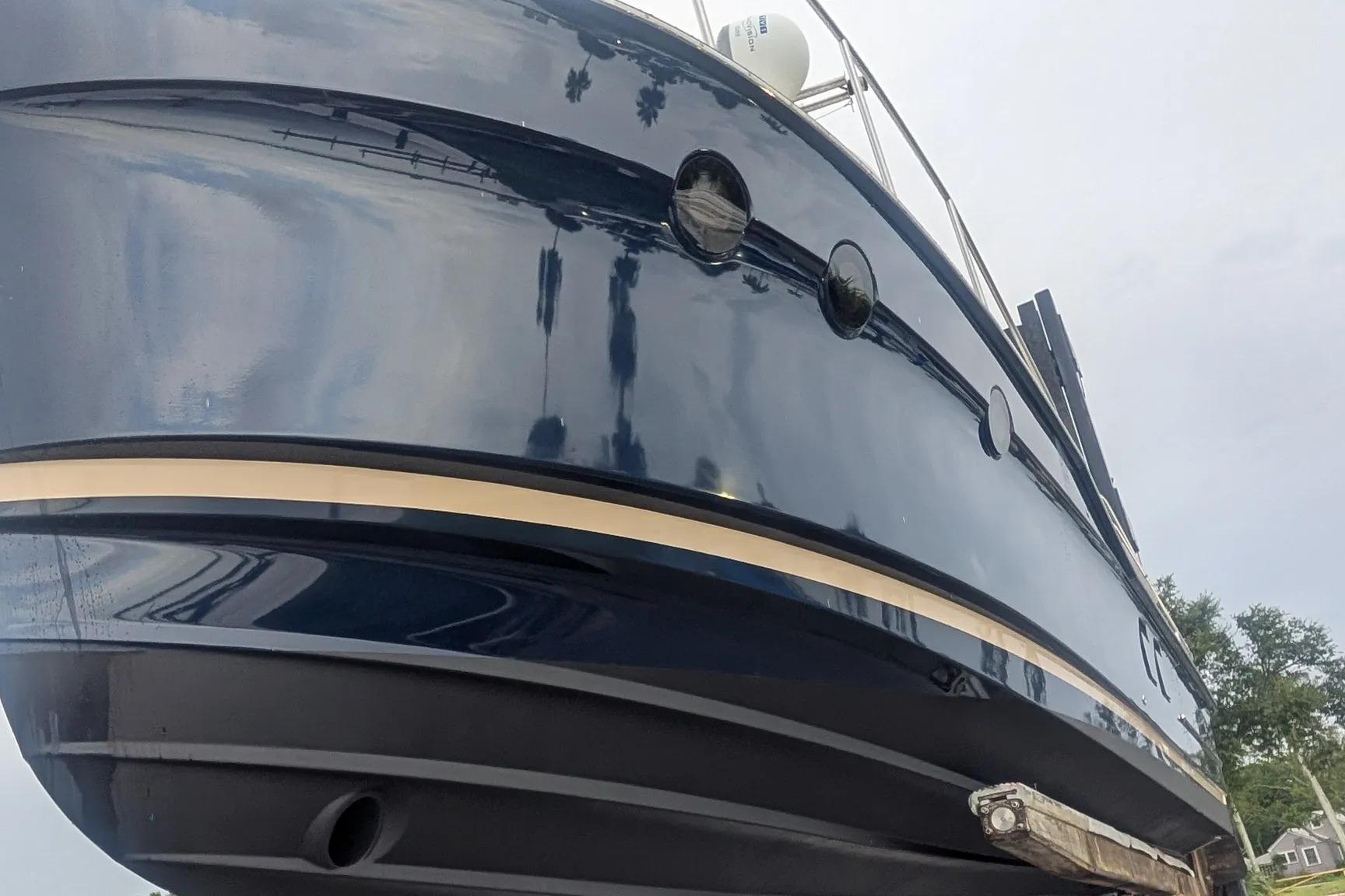 2015 Ranger Tugs R-29 S boat hull, glossy finish, docked outdoors.