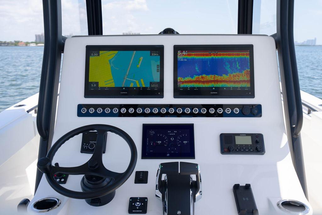 Control panel of a 2027 Reef Runner 340 boat with navigation screens.