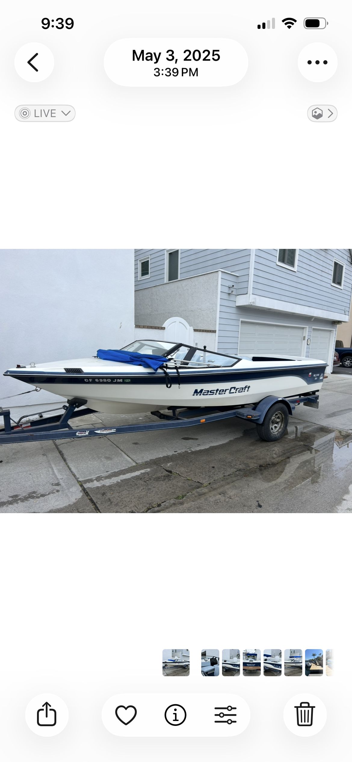 1987 MasterCraft ProStar 190 on a trailer in front of a house.