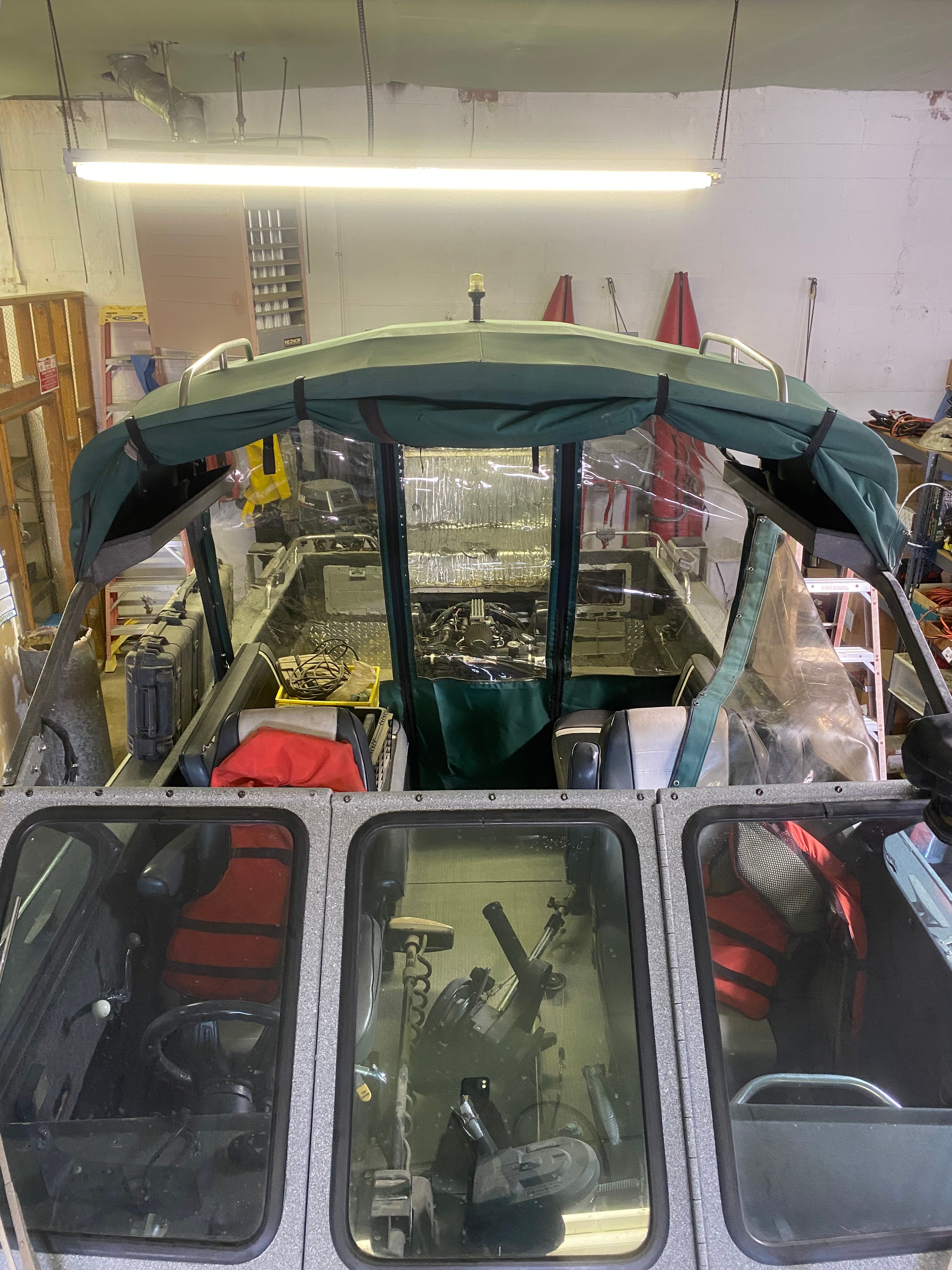 Interior view of a 1993 Jetcraft Fastwater boat in a workshop.