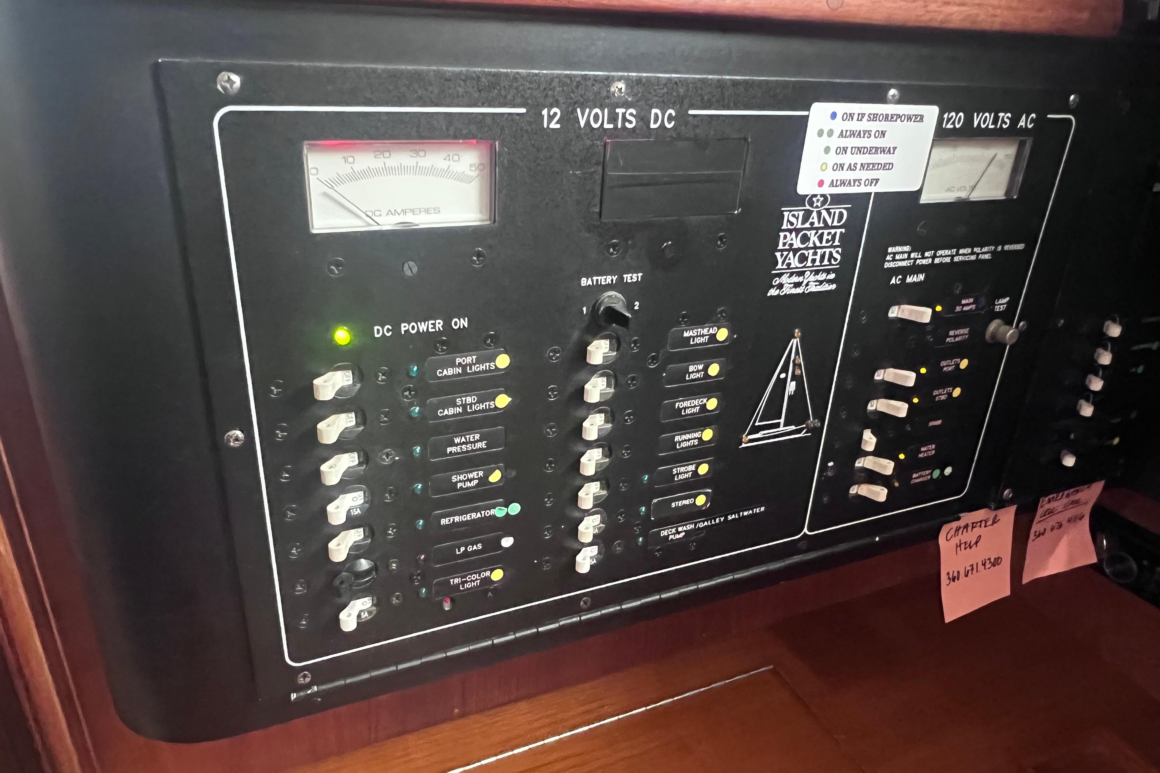 Electrical control panel of a 1997 Island Packet 37 yacht, featuring DC and AC switches.