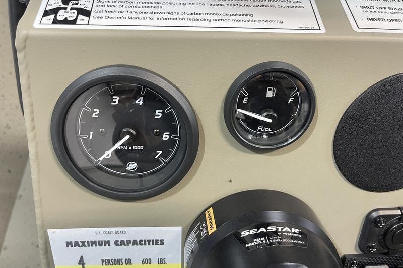 Dashboard of 2025 SeaArk Shadow 18T boat with RPM and fuel gauges.