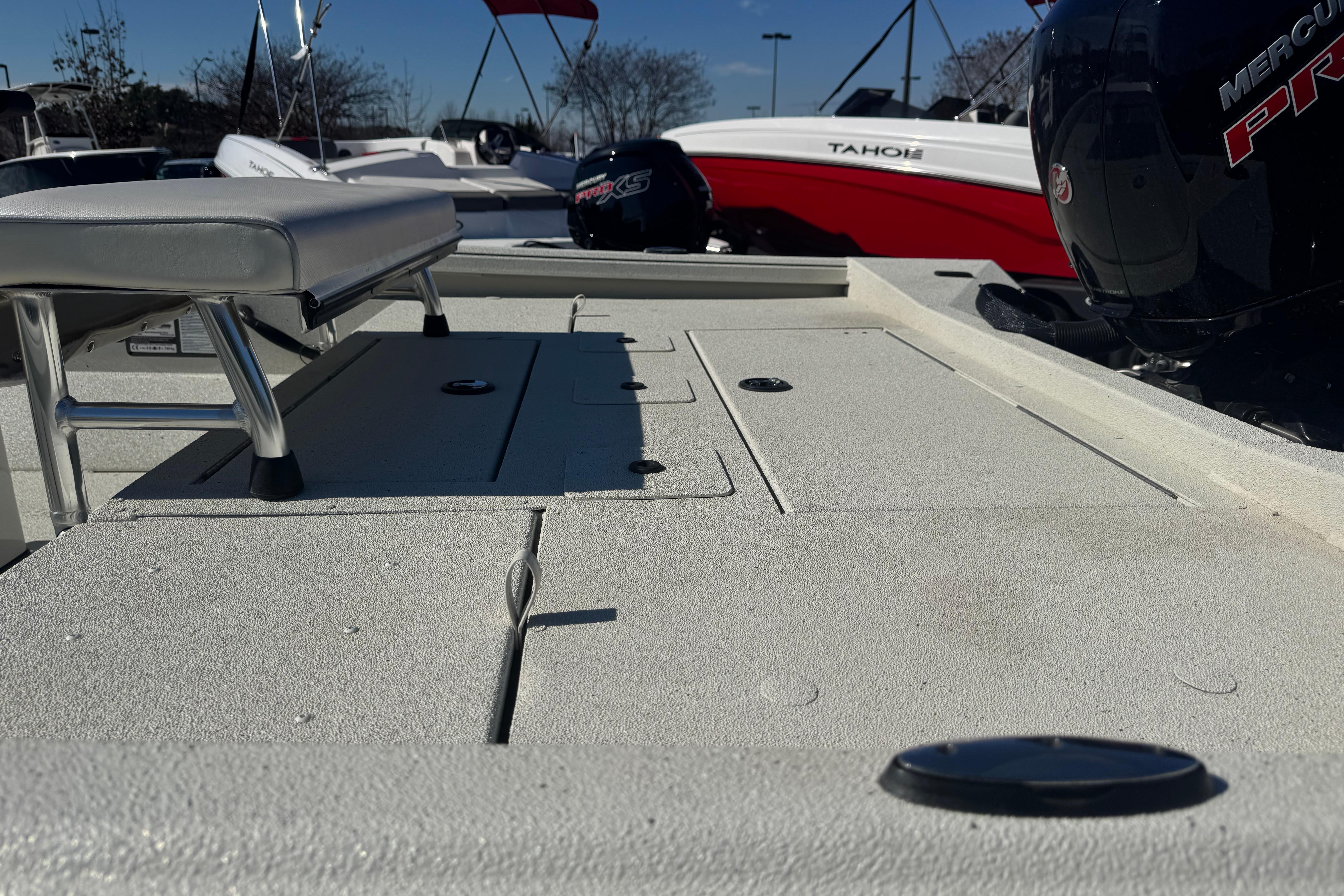2026 Ranger RB200 boat deck with seating and Mercury engine, parked near other boats.