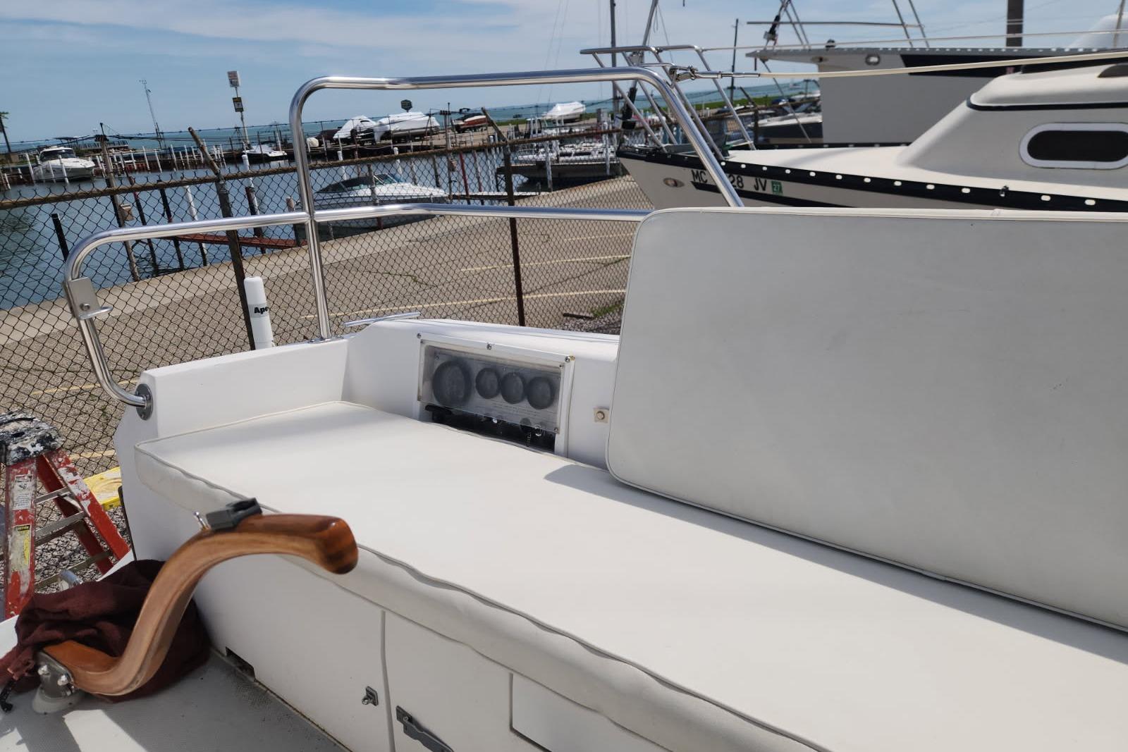 1990 Catalina Capri sailboat cockpit with white seating, docked at marina.