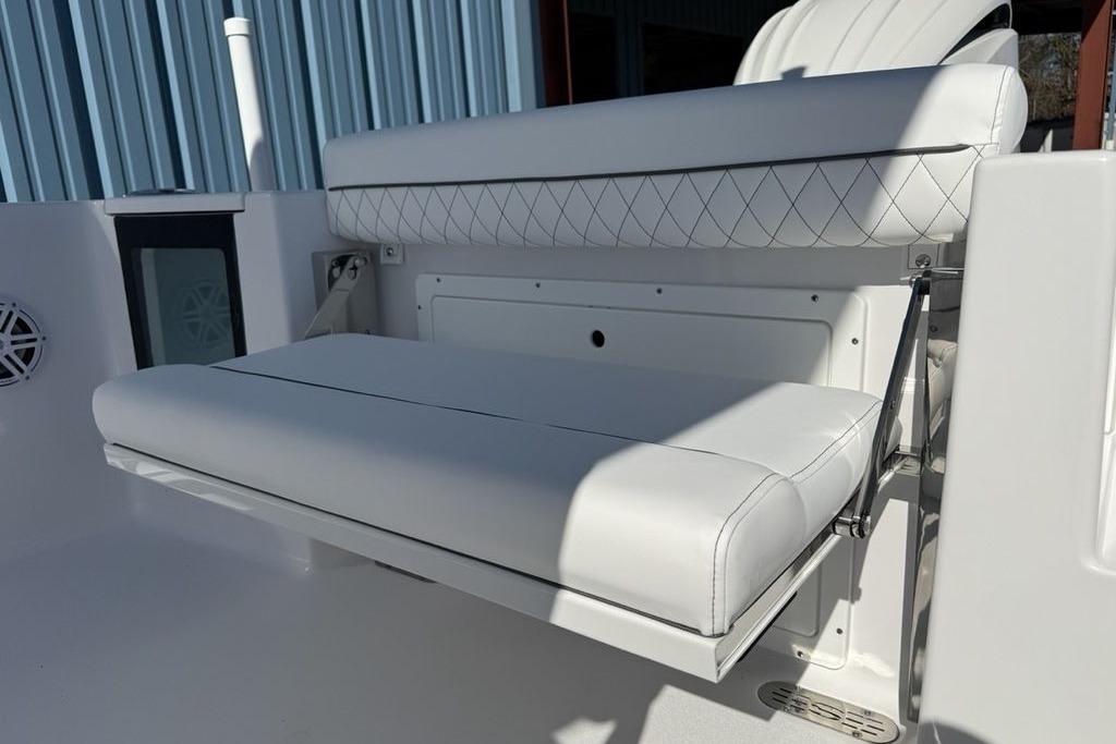 2026 Sportsman Open 232 Center Console boat with white cushioned seating.