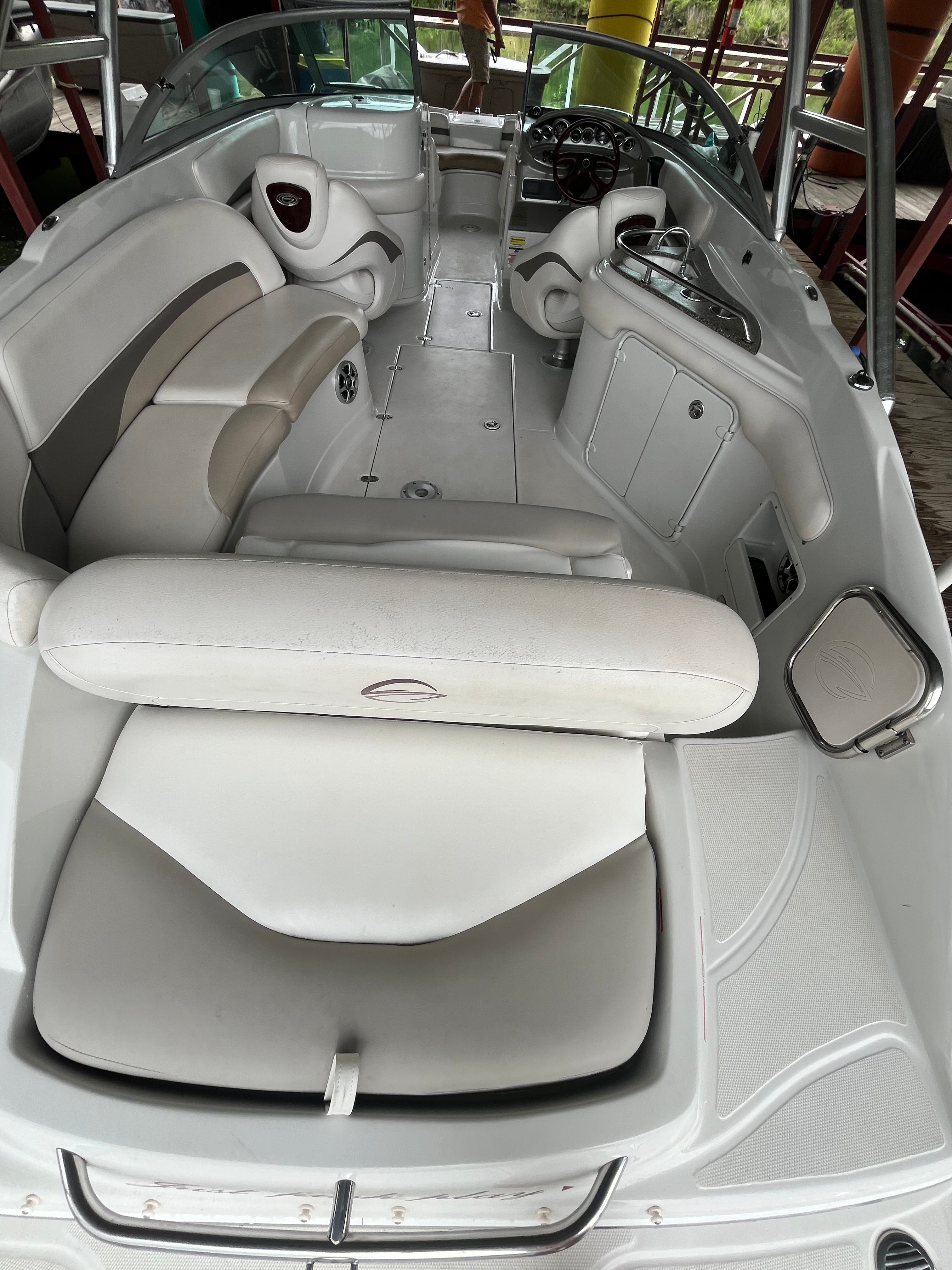 Interior view of a 2008 Crownline 252EX boat with white upholstery and a helm console.