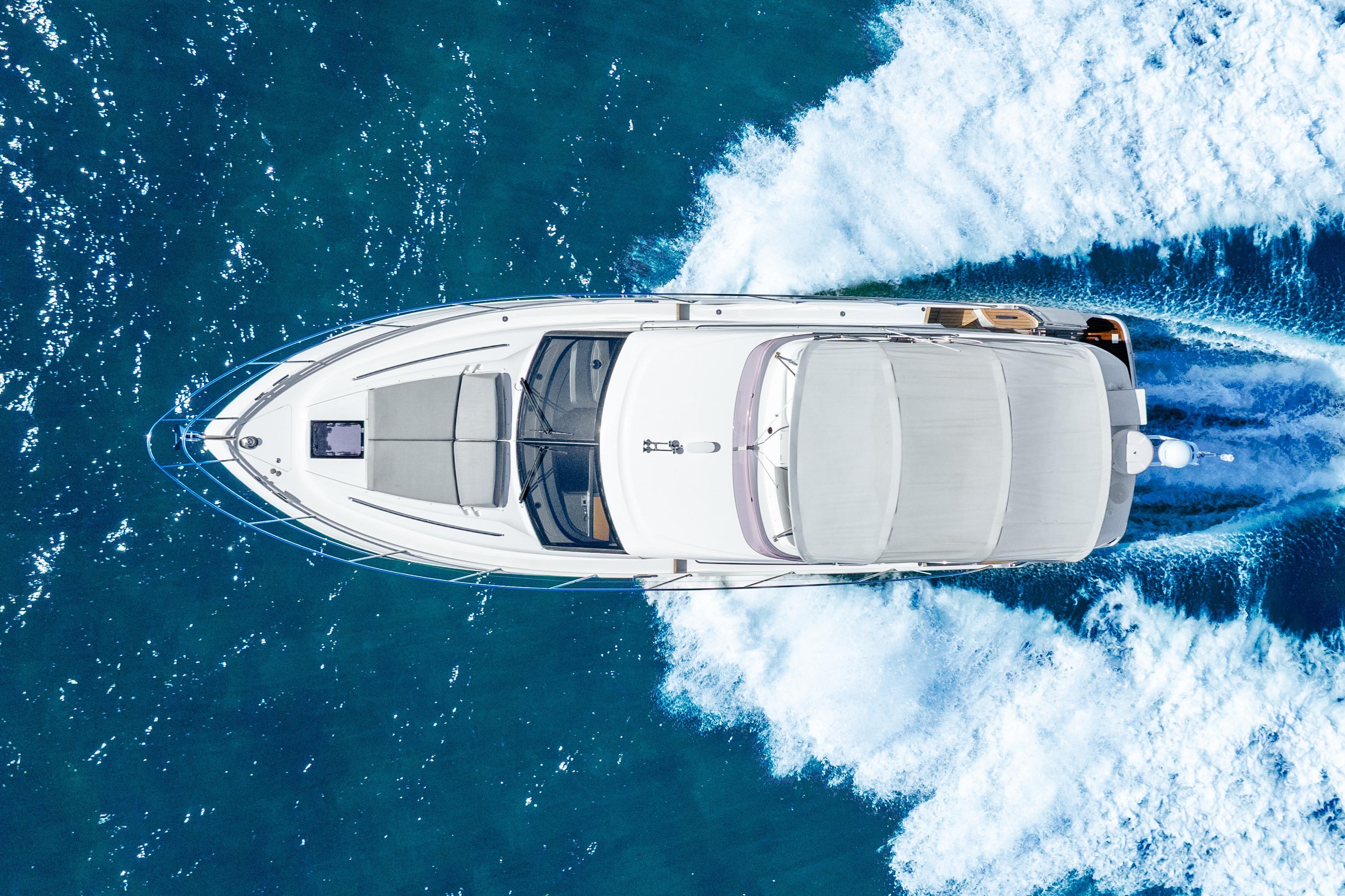Aerial view of 2018 Princess F49 yacht cruising on blue ocean waters.