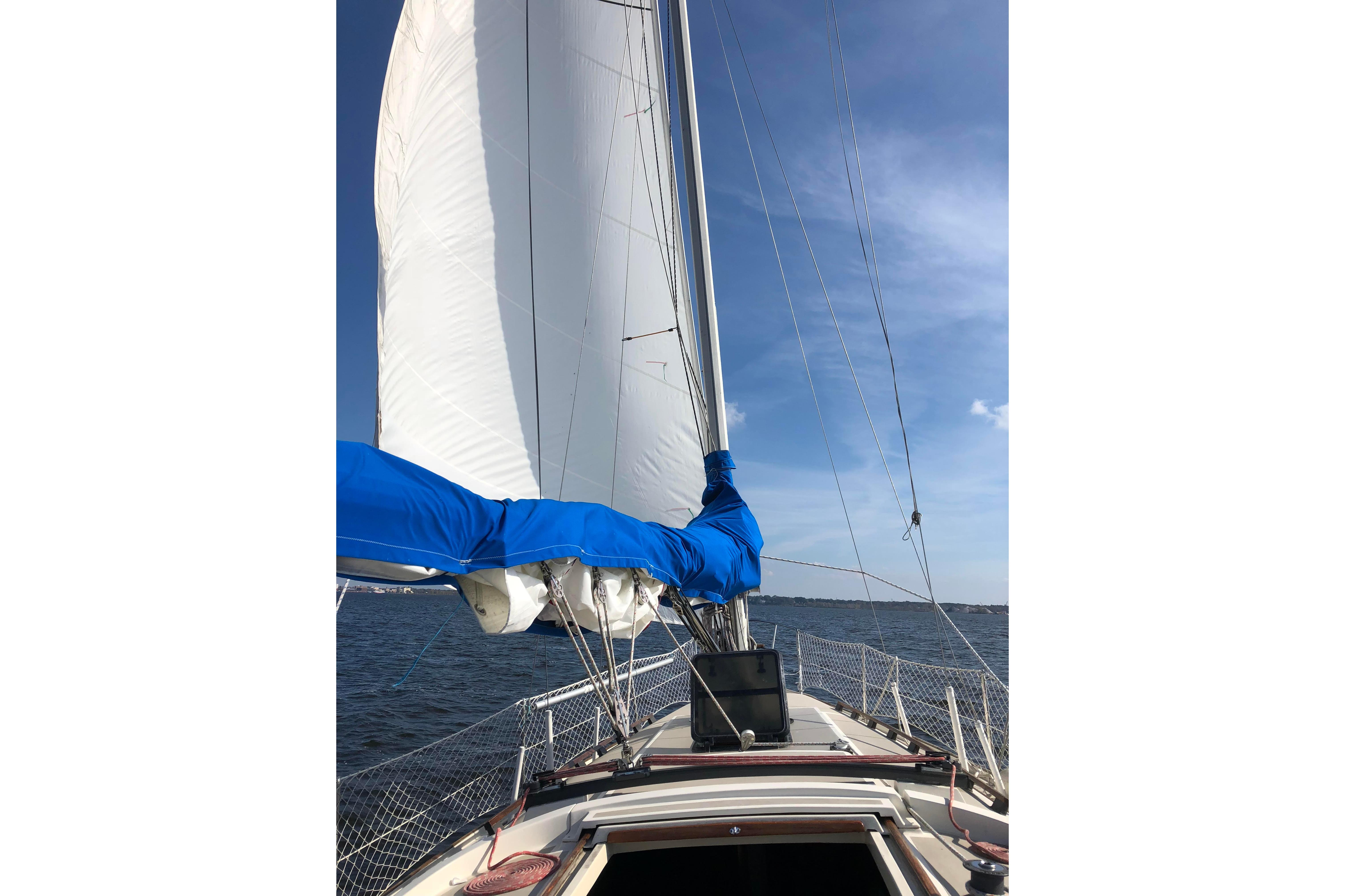 1983 O'Day 34 sailboat with sails up on a sunny day at sea.