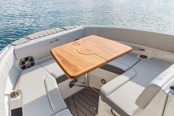 Manufacturer Provided Image: 2025 Sea Ray SDX 250 boat interior with wooden table and cushioned seating.