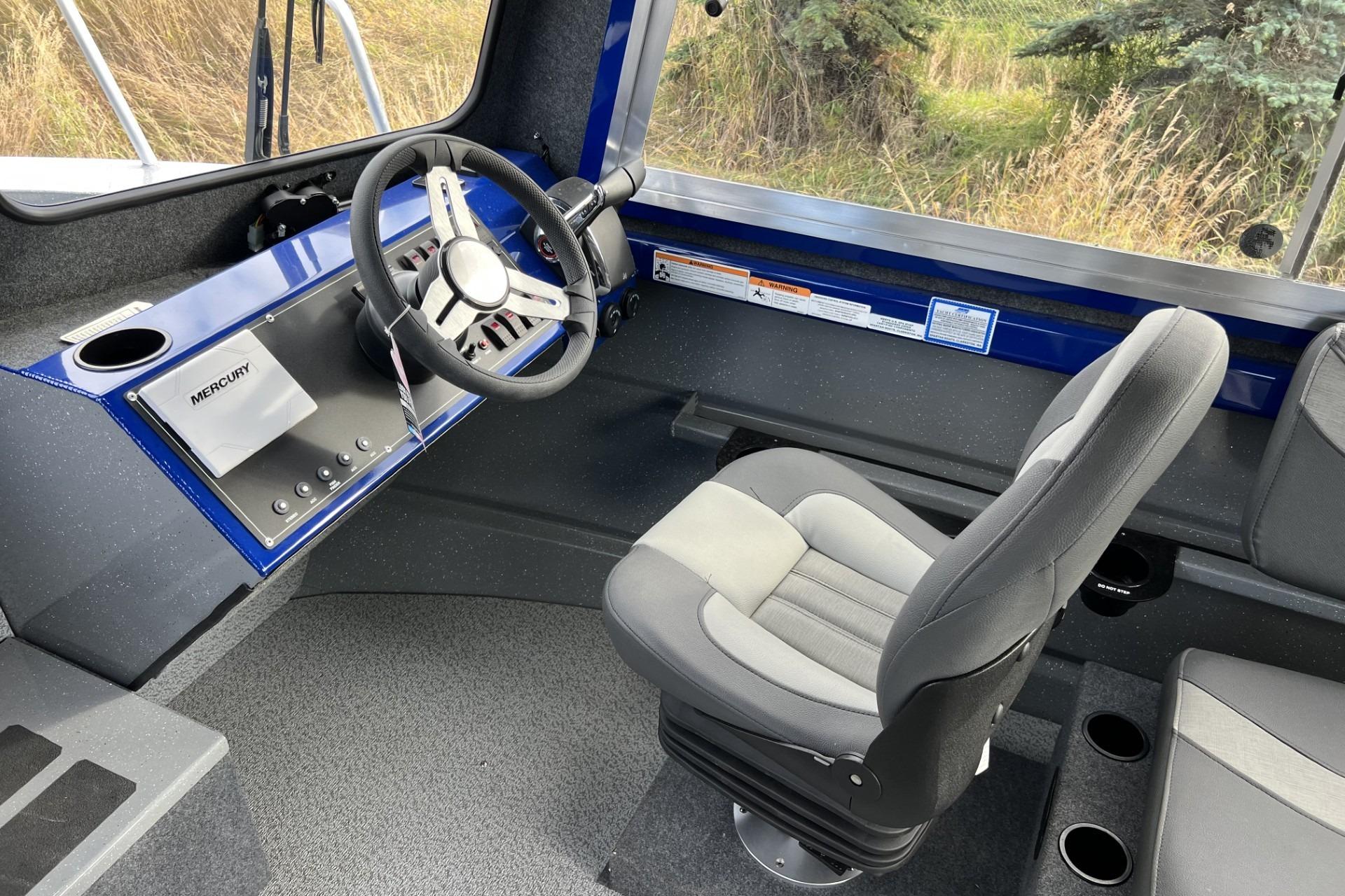 2024 Spartan 26 Maximus Pro XL boat interior with steering wheel and captain's chair.