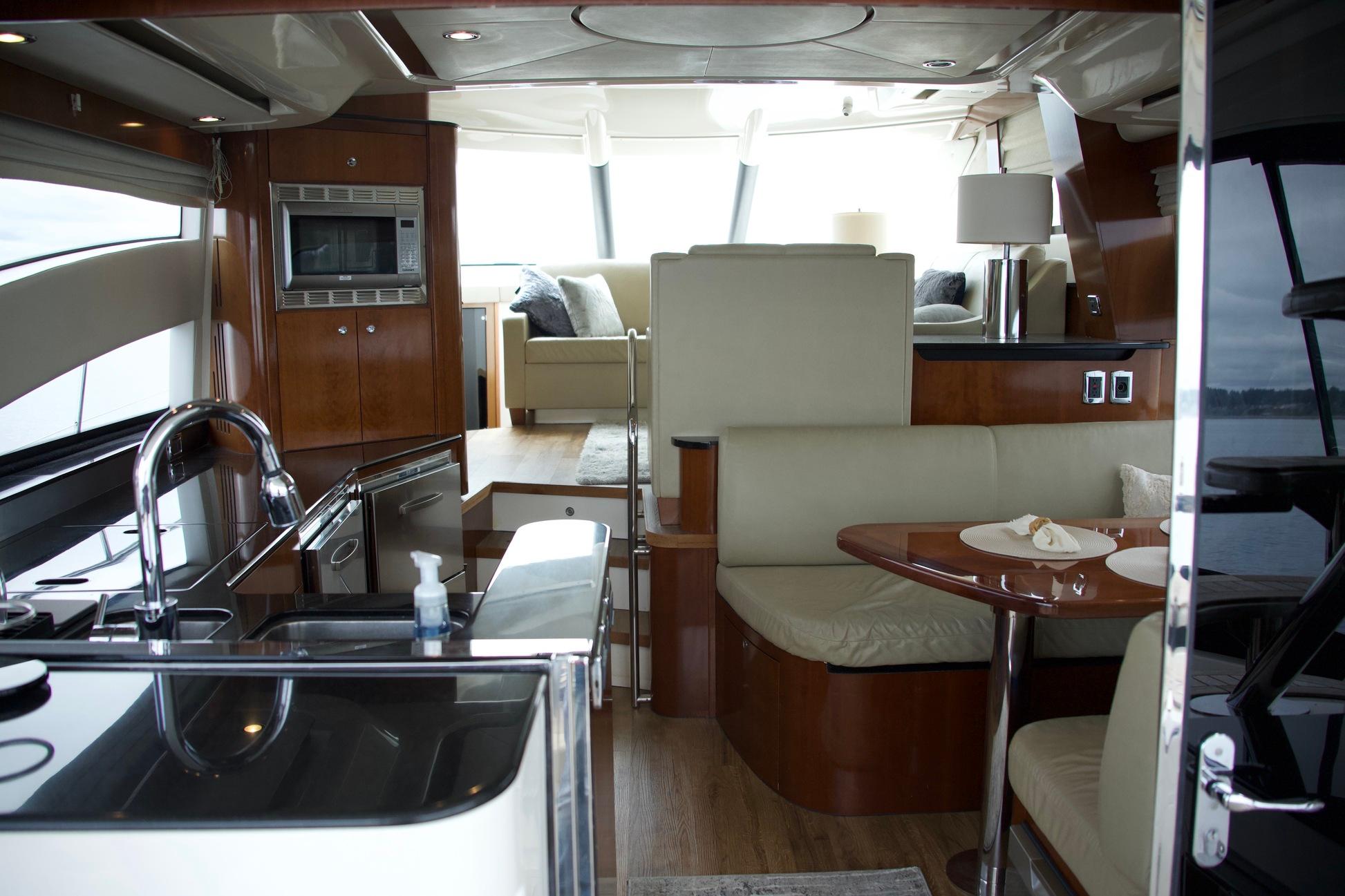 Luxurious interior of 2012 Meridian 541 Sedan yacht with modern kitchen and seating area.