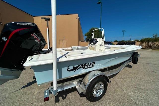 2026 Mako 18 Pro Skiff boat on trailer, outdoor setting, clear sky.