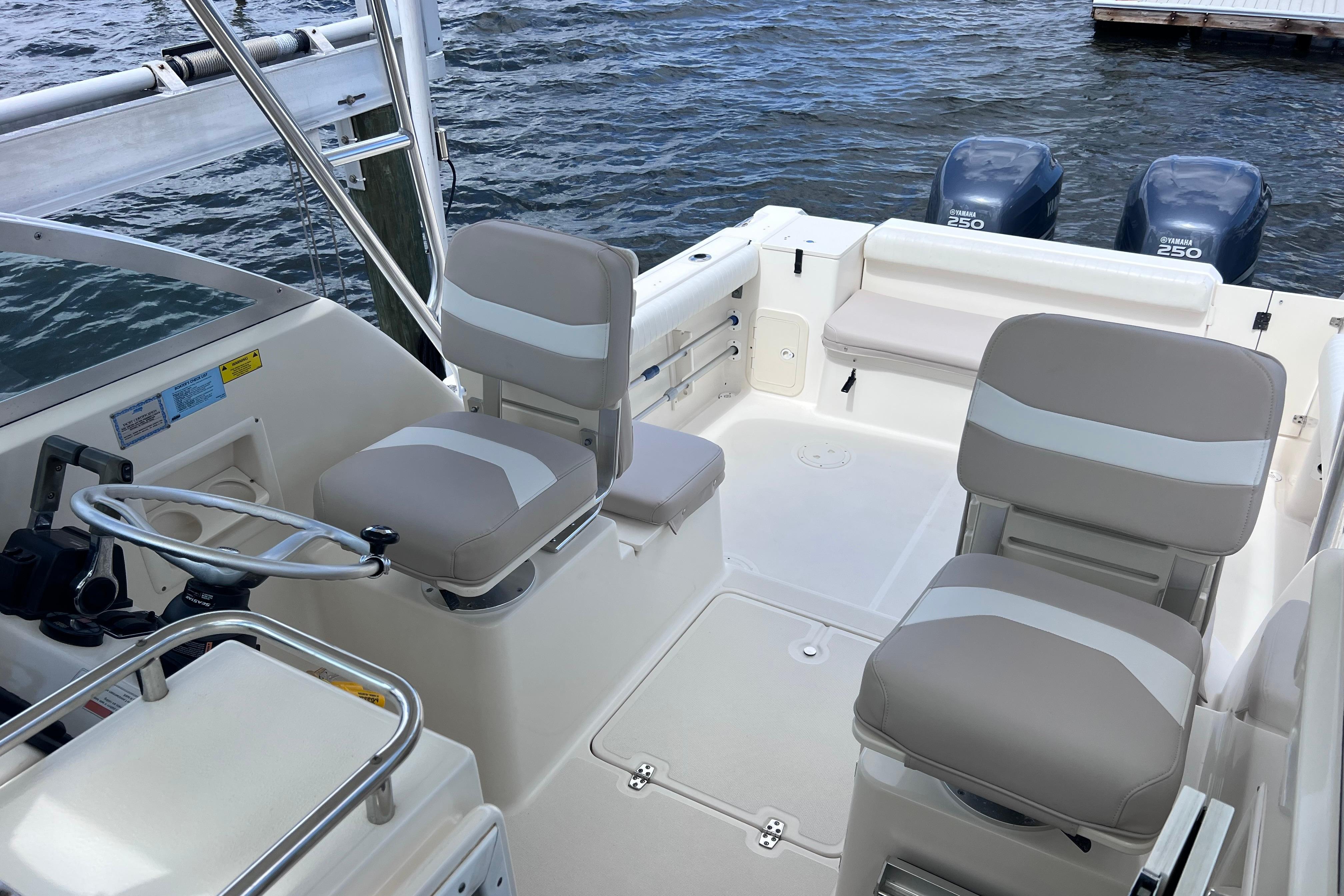 2004 Pursuit 2870 Walkaround boat interior with seating and dual Yamaha 250 engines.