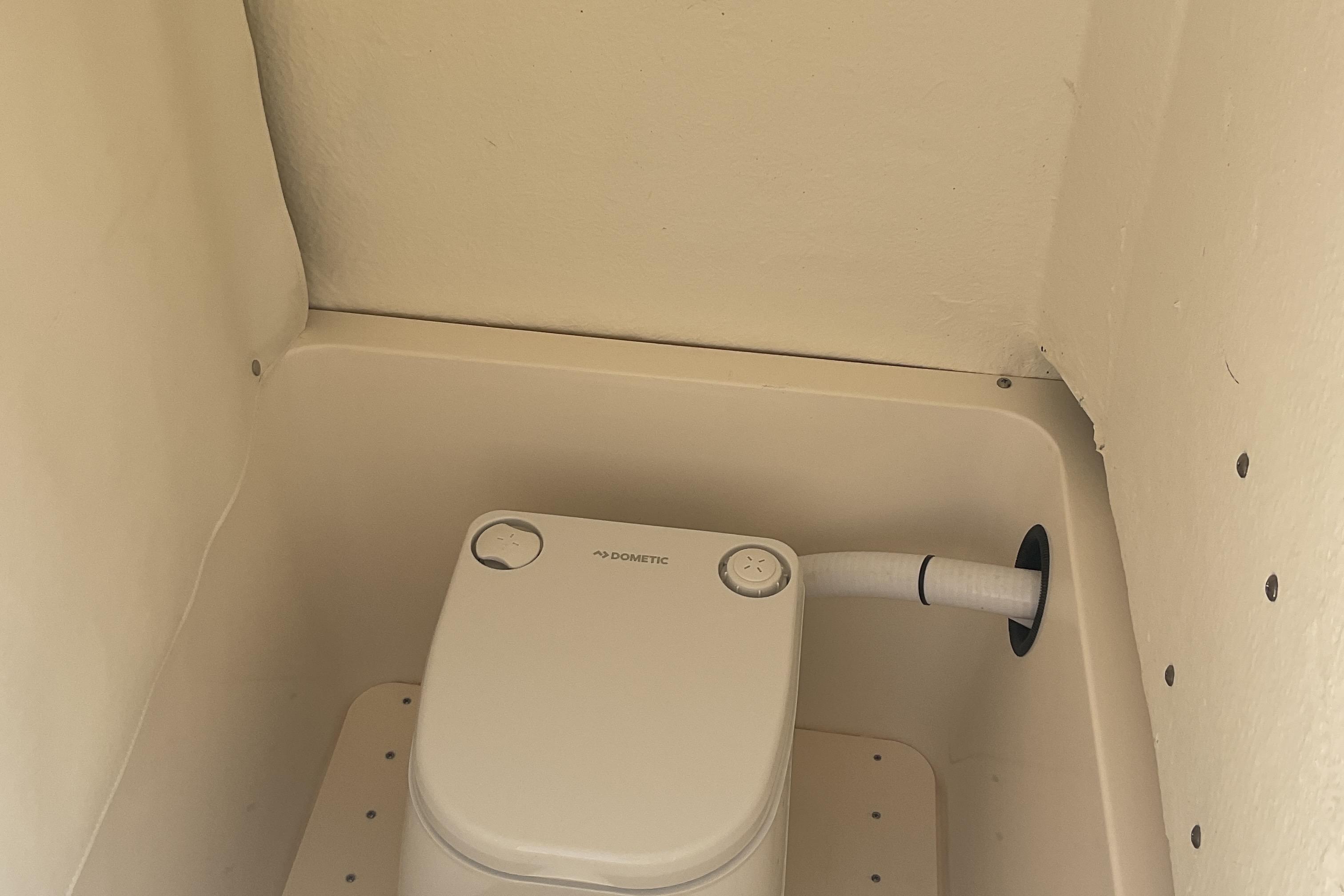 Compact marine toilet in 2023 Sea Born SX239 Offshore boat bathroom.