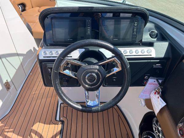 2024 Crownline Eclipse E255 dashboard with steering wheel and dual displays.