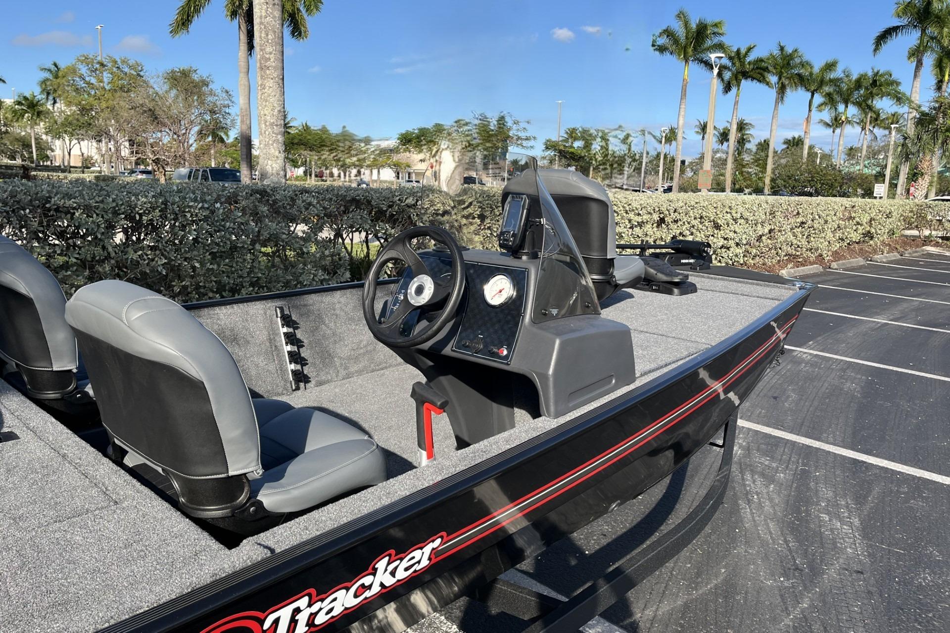 2026 Tracker Bass Tracker Classic XL boat parked, featuring steering console and seating.