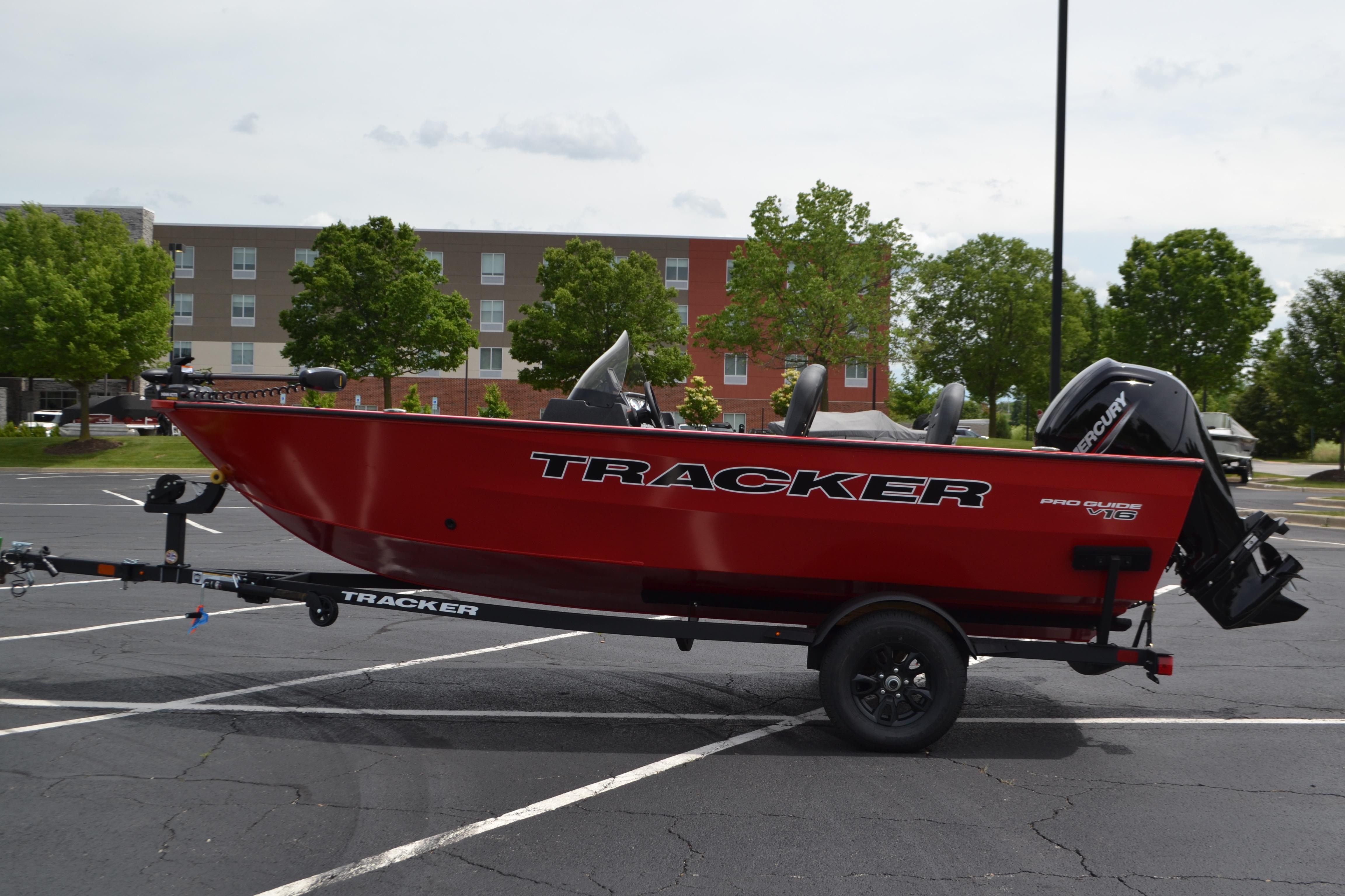 2026 Tracker Pro Guide V-16 SC boat on trailer in parking lot.