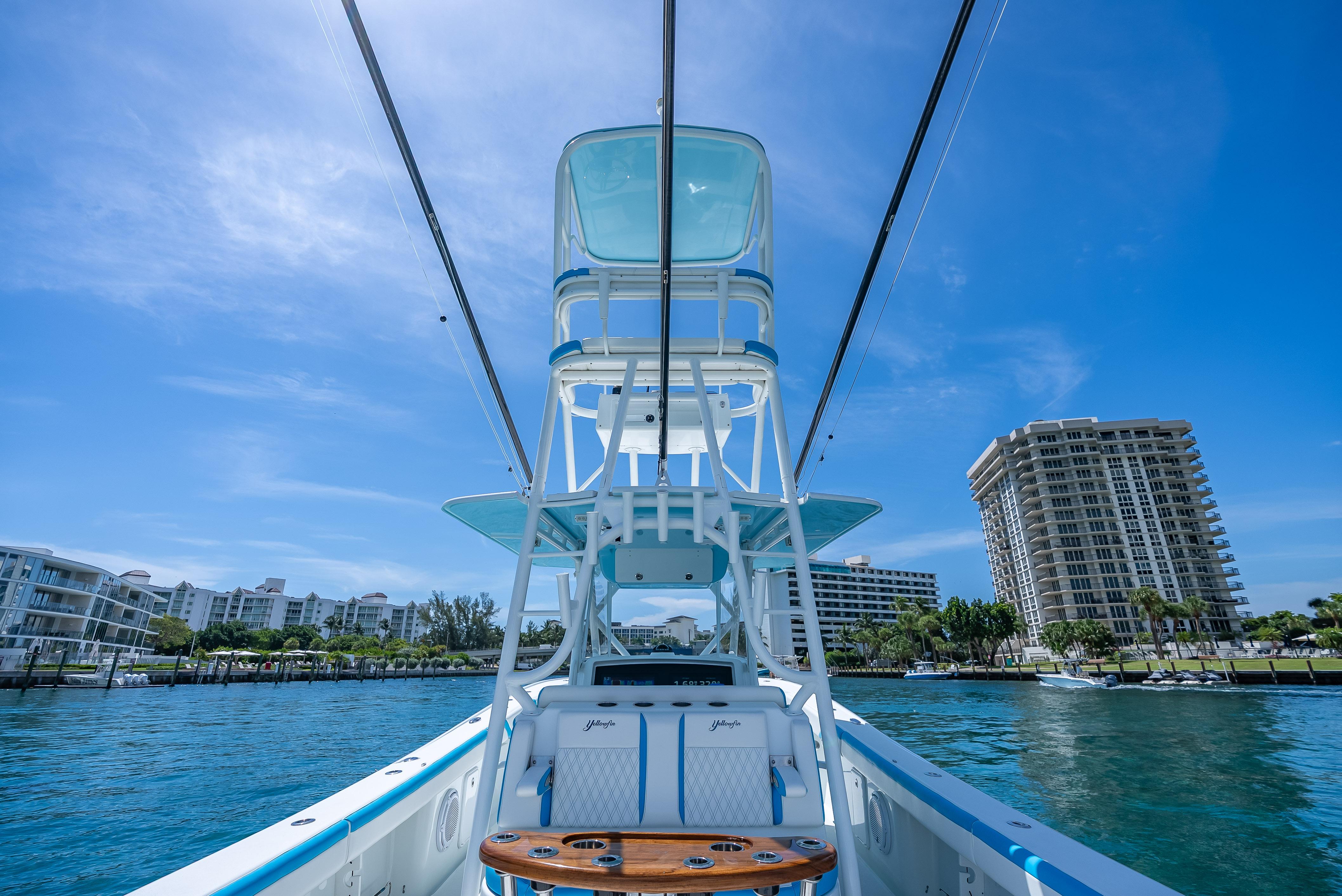 2016 Yellowfin 39 Offshore boat on water, with cityscape background under clear blue sky.