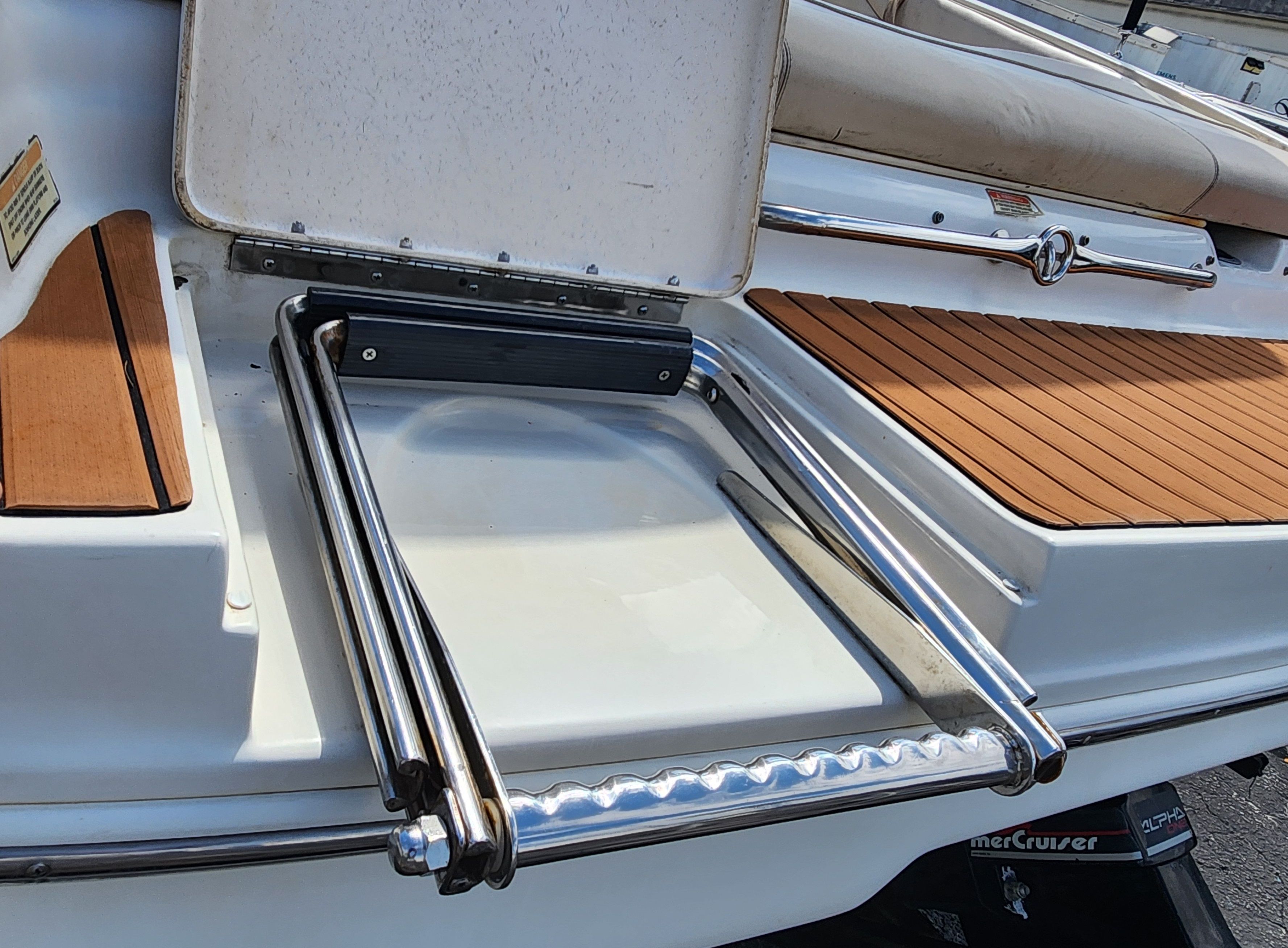 A swim platform with a retractable ladder on a boat.