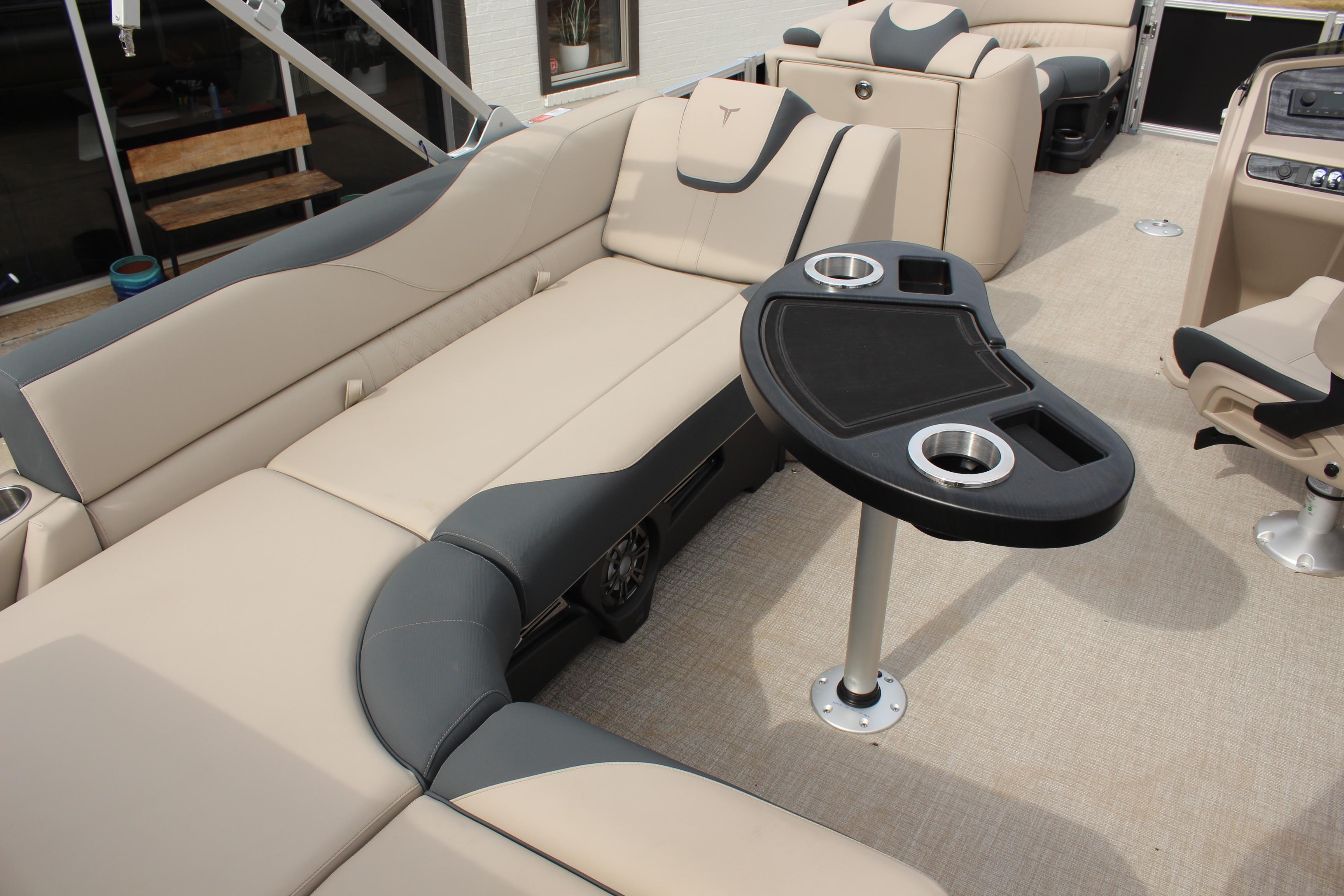 2026 Tahoe Pontoon LTZ interior with beige seating and a black table.