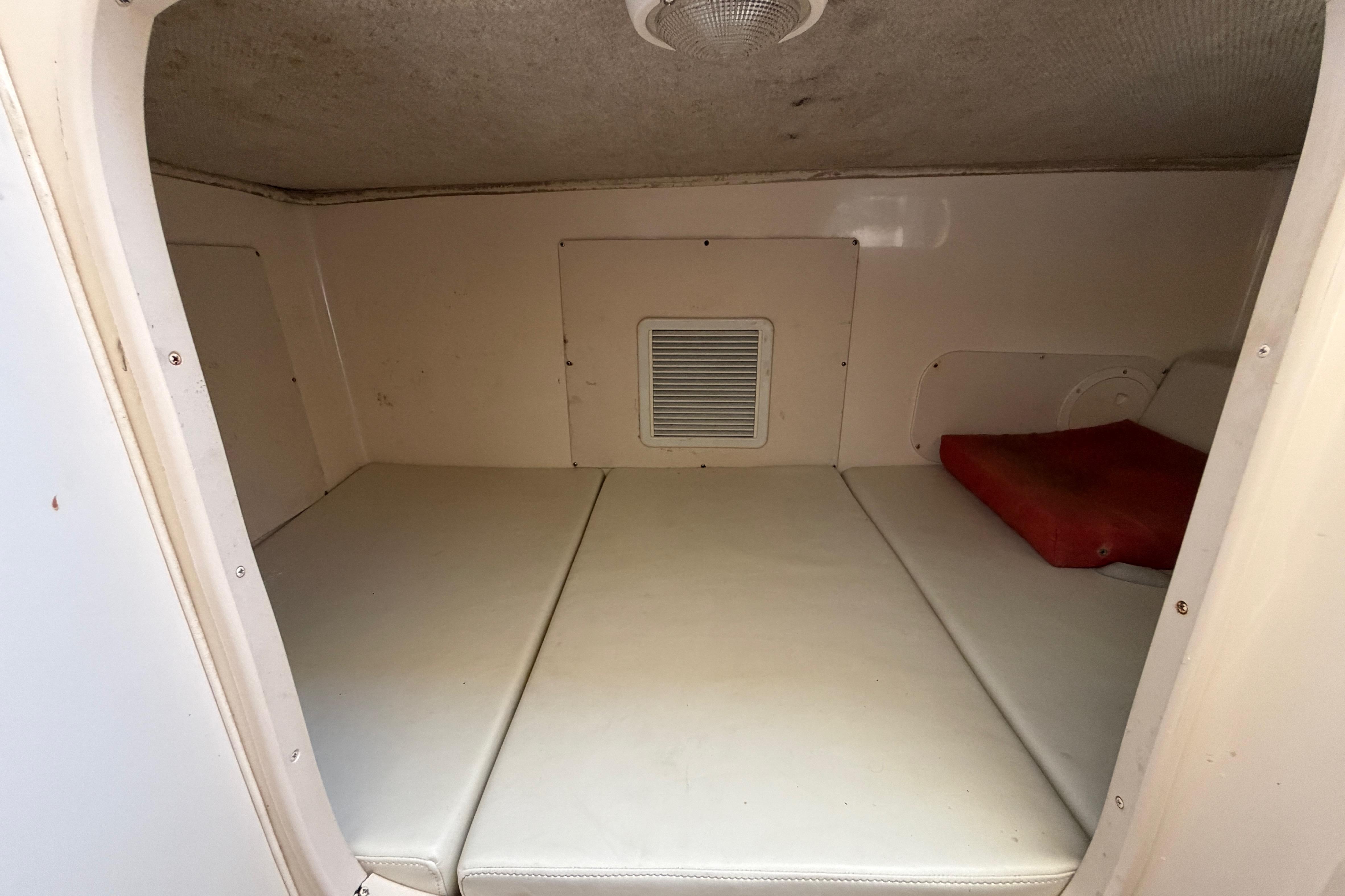 2006 Grady-White Sailfish 282 cabin interior with cushioned seating and ventilation.