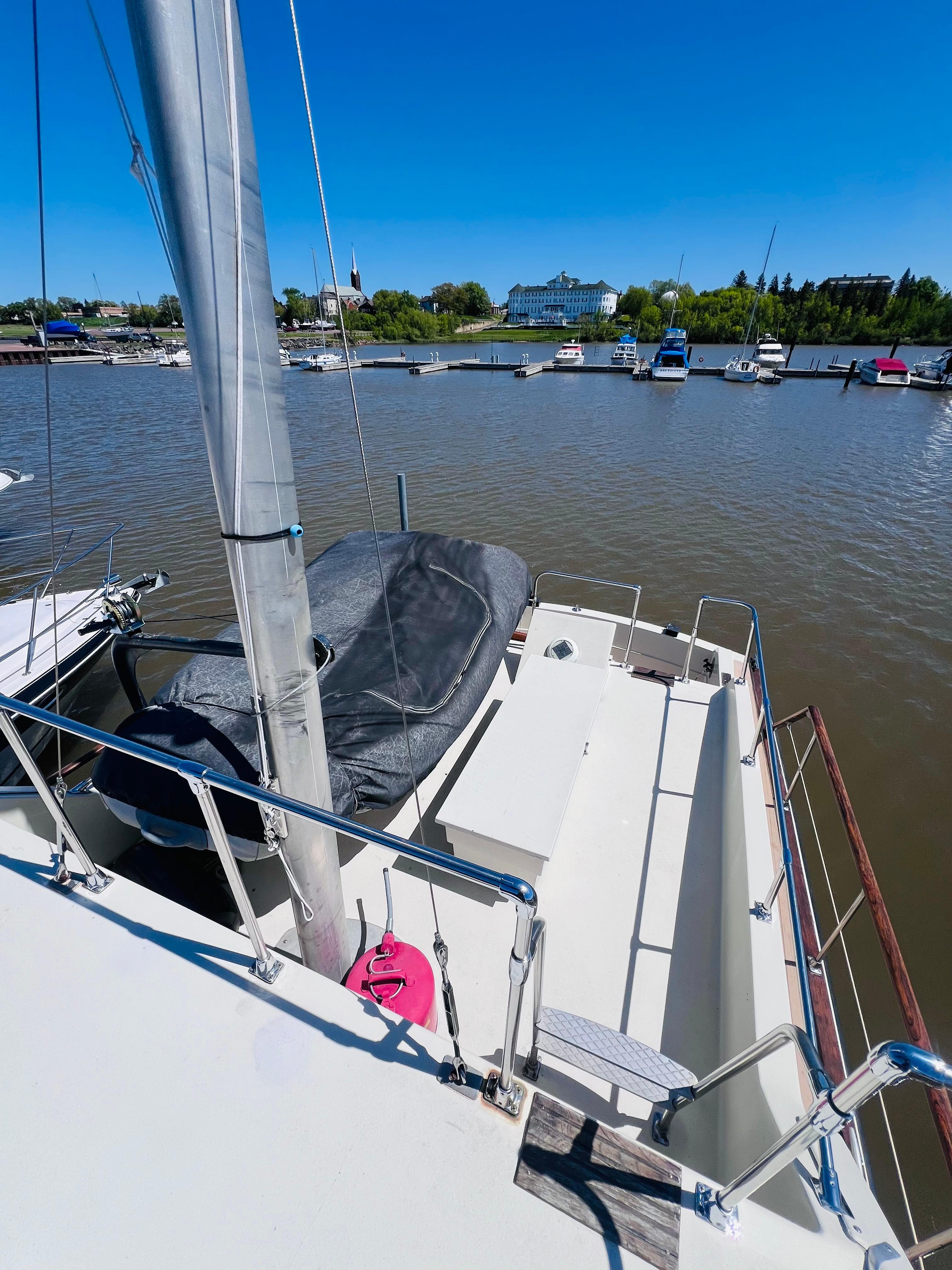 1974 Tollycraft 40 Tri-Cabin Motoryacht docked at a marina under clear blue skies.
