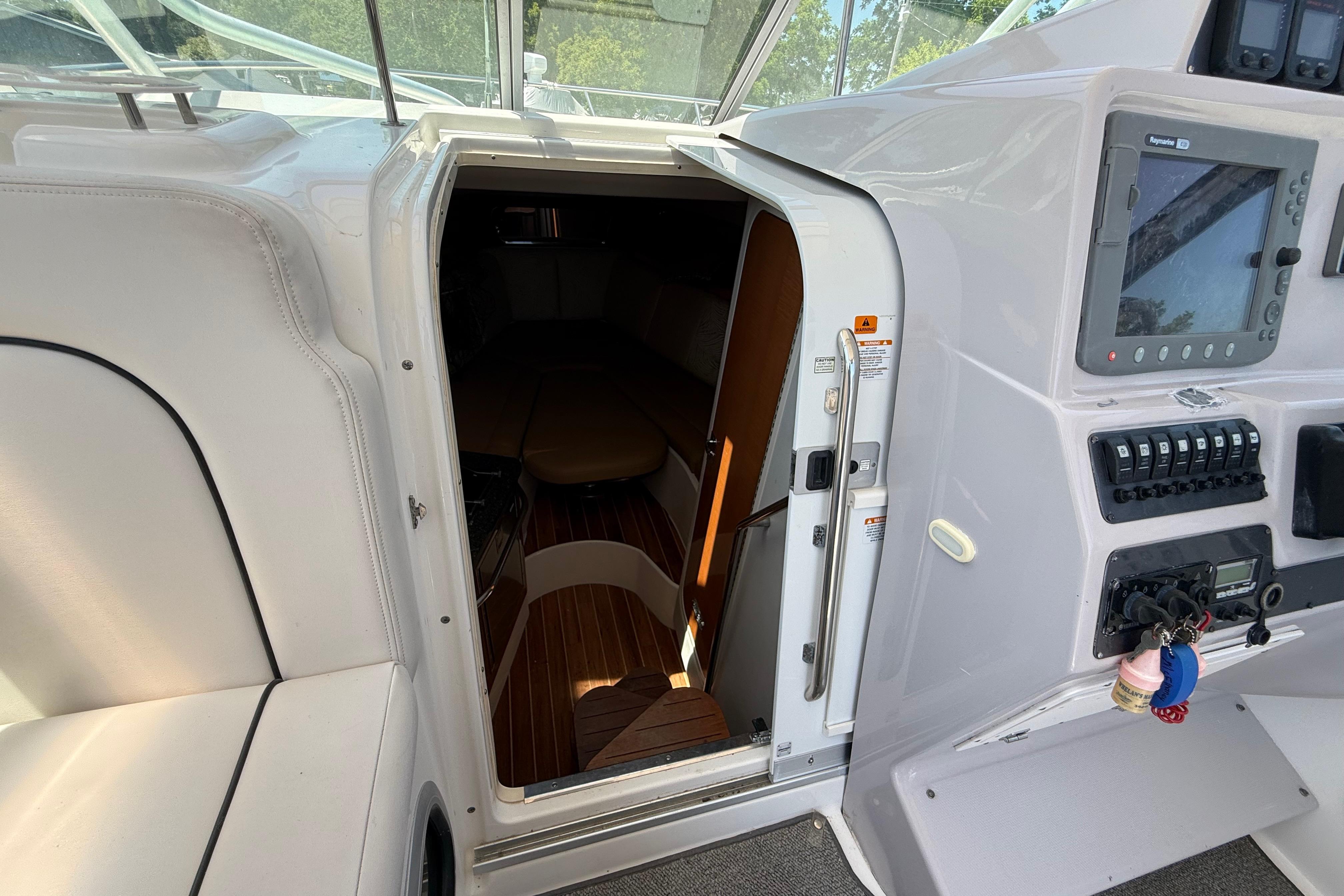 2007 Robalo R305 Walkaround cabin entrance with control panel and seating area.