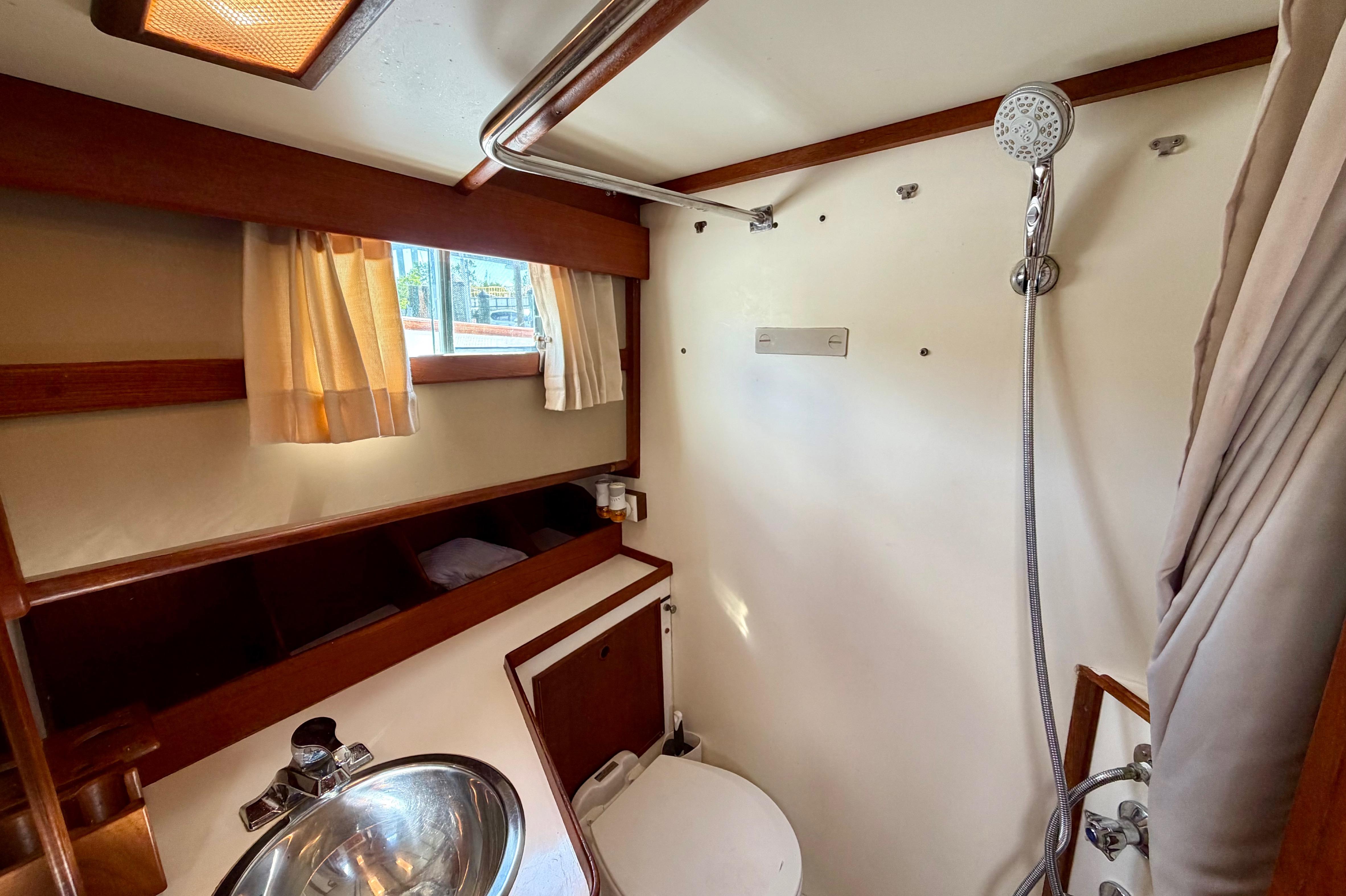 Bathroom interior of 1983 Grand Banks 32 Sedan with shower and sink.
