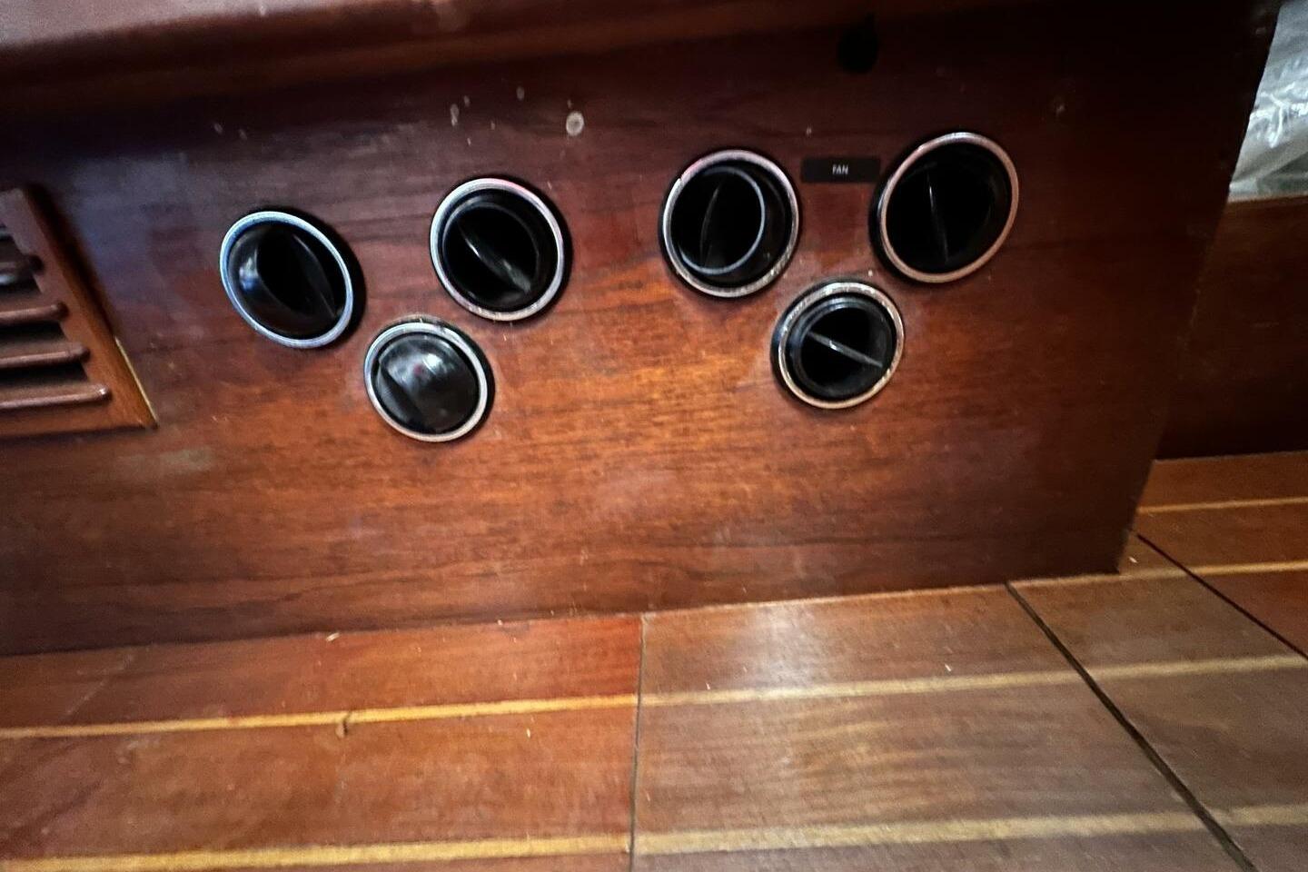 Wooden interior panel with six circular air vents, Hughes 3910, 1979 model.