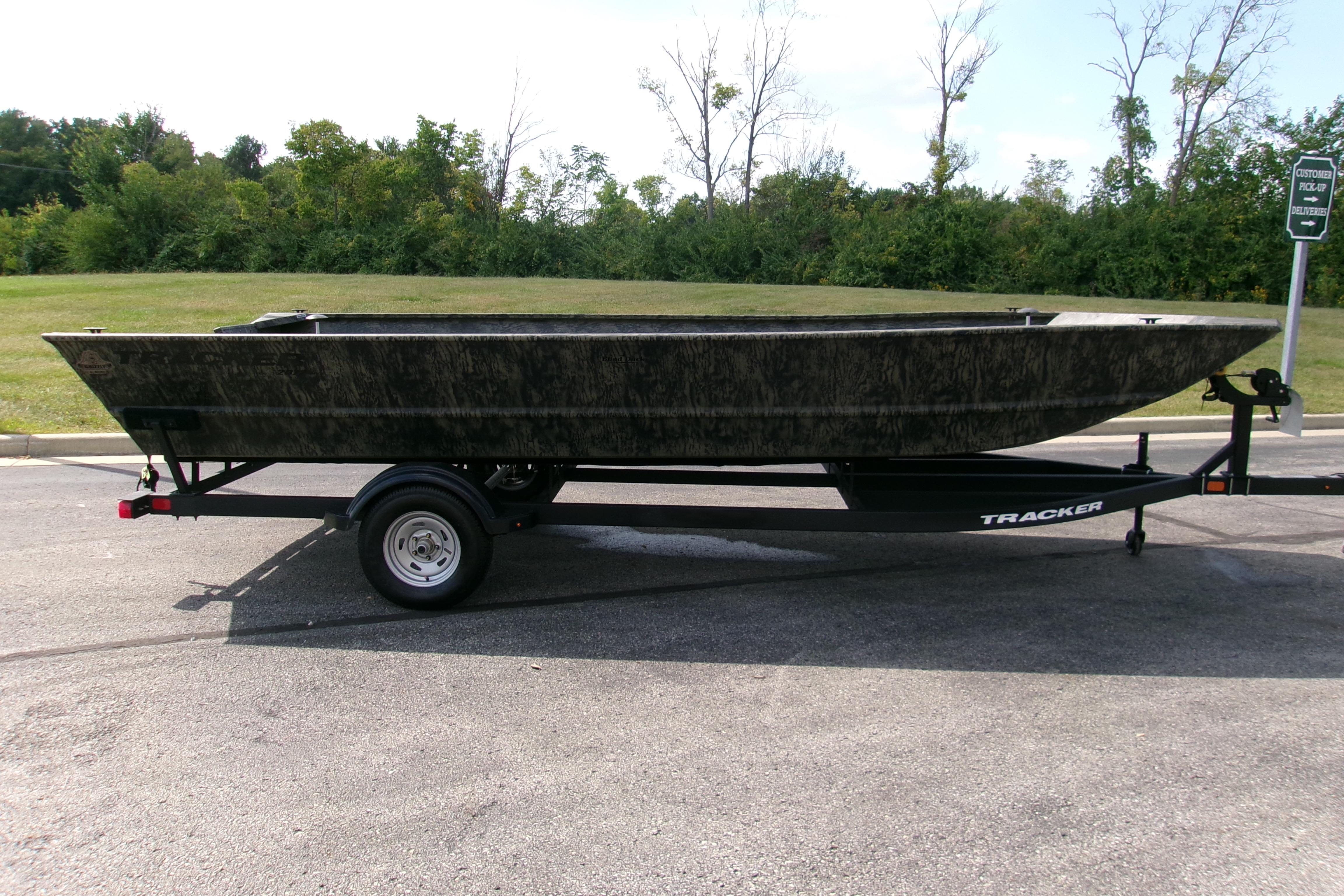2026 Tracker Grizzly 2072 Utility boat on trailer, parked outdoors.