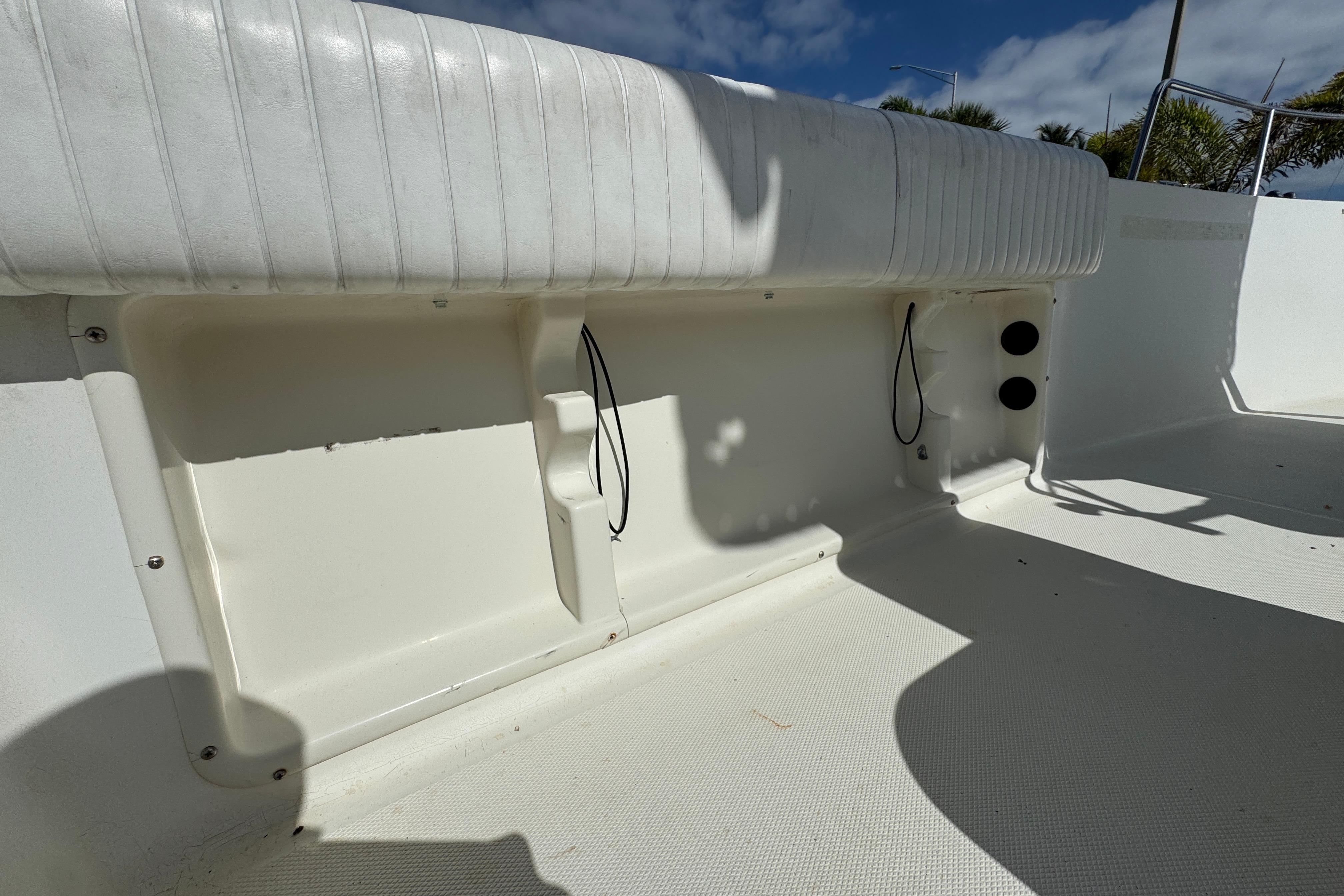 2002 Hydra-Sports 212 CC boat interior with white seating and storage compartments.