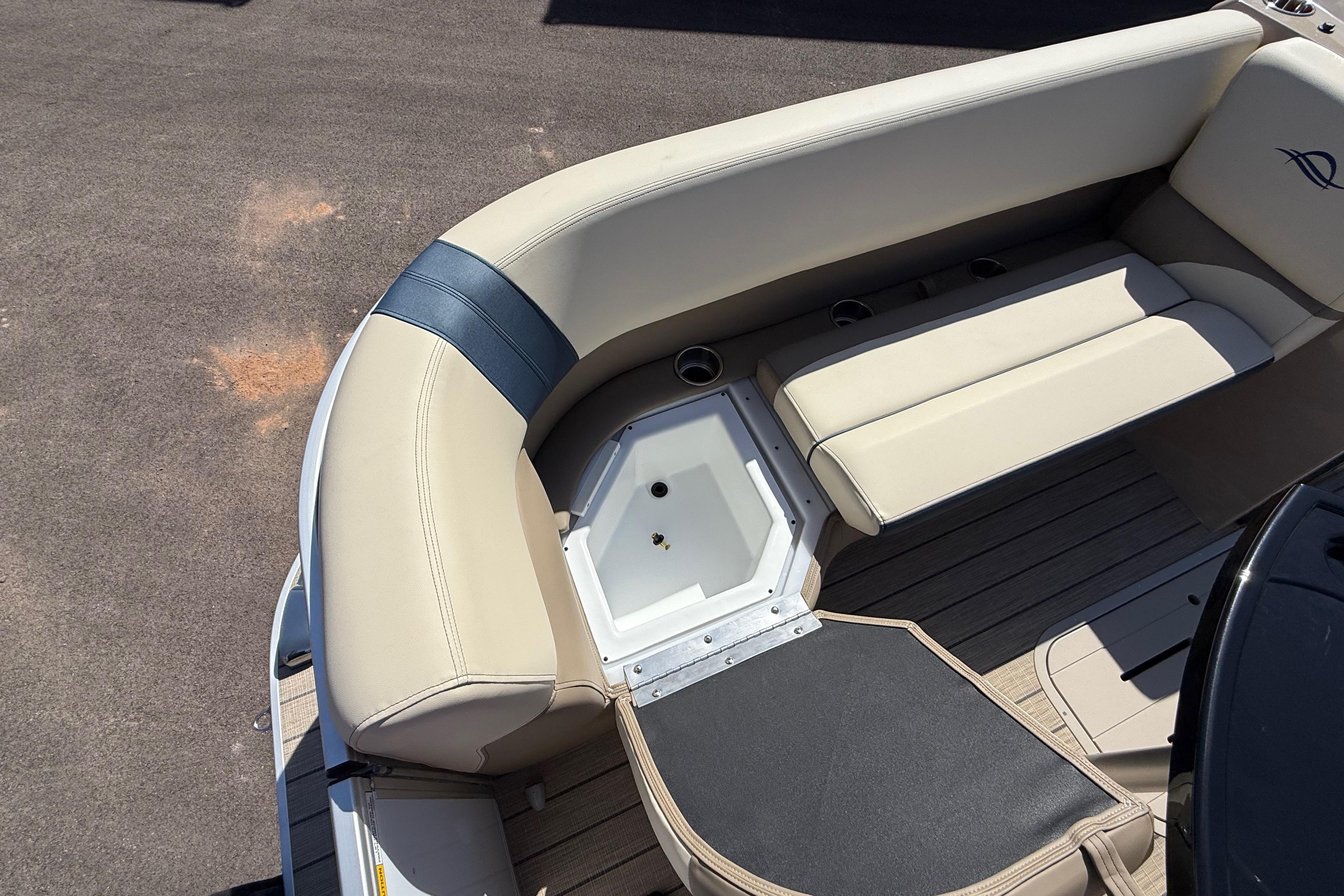 Luxurious seating on 2026 SunCatcher Select 322SL boat, featuring beige upholstery and storage compartment.