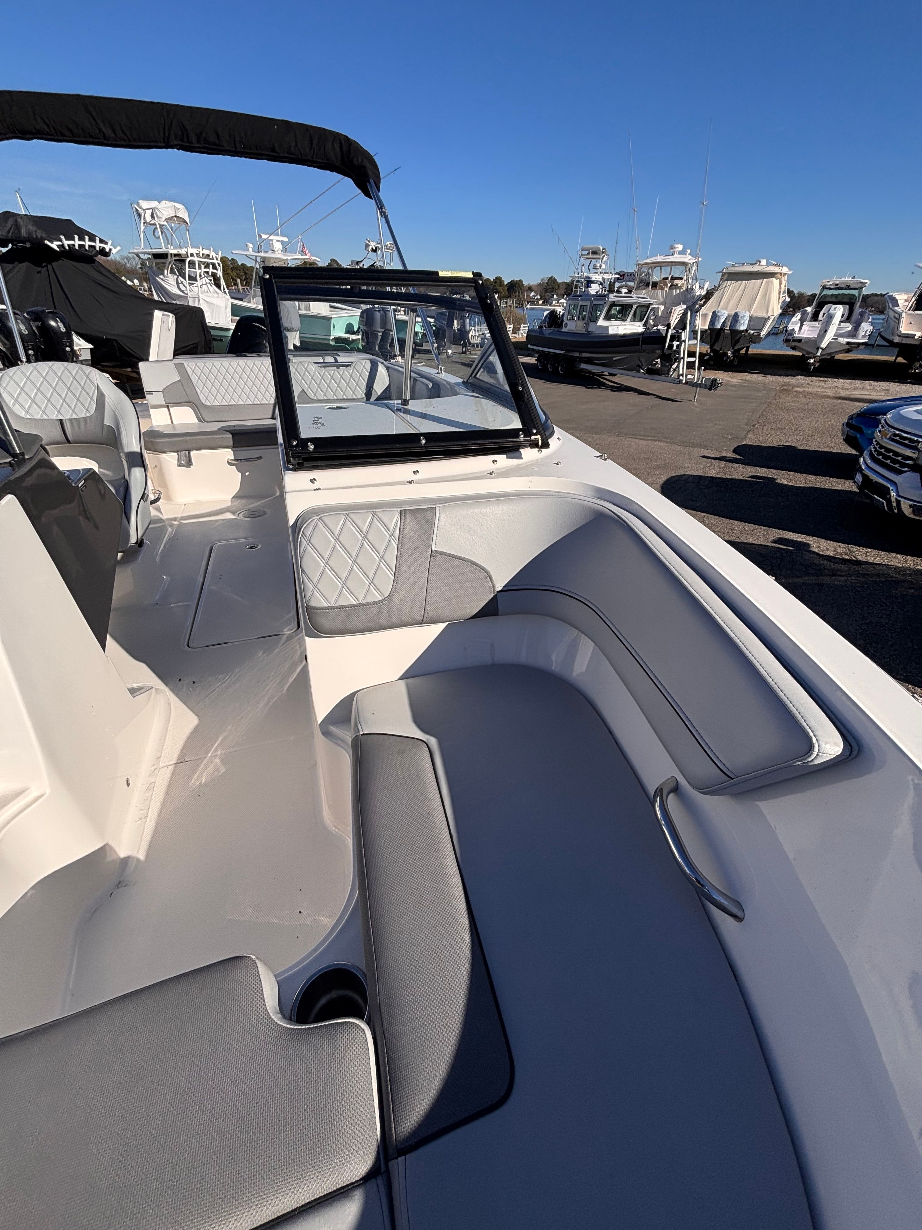 2024 Bayliner VR6 Bowrider OB with gray seating at the marina.