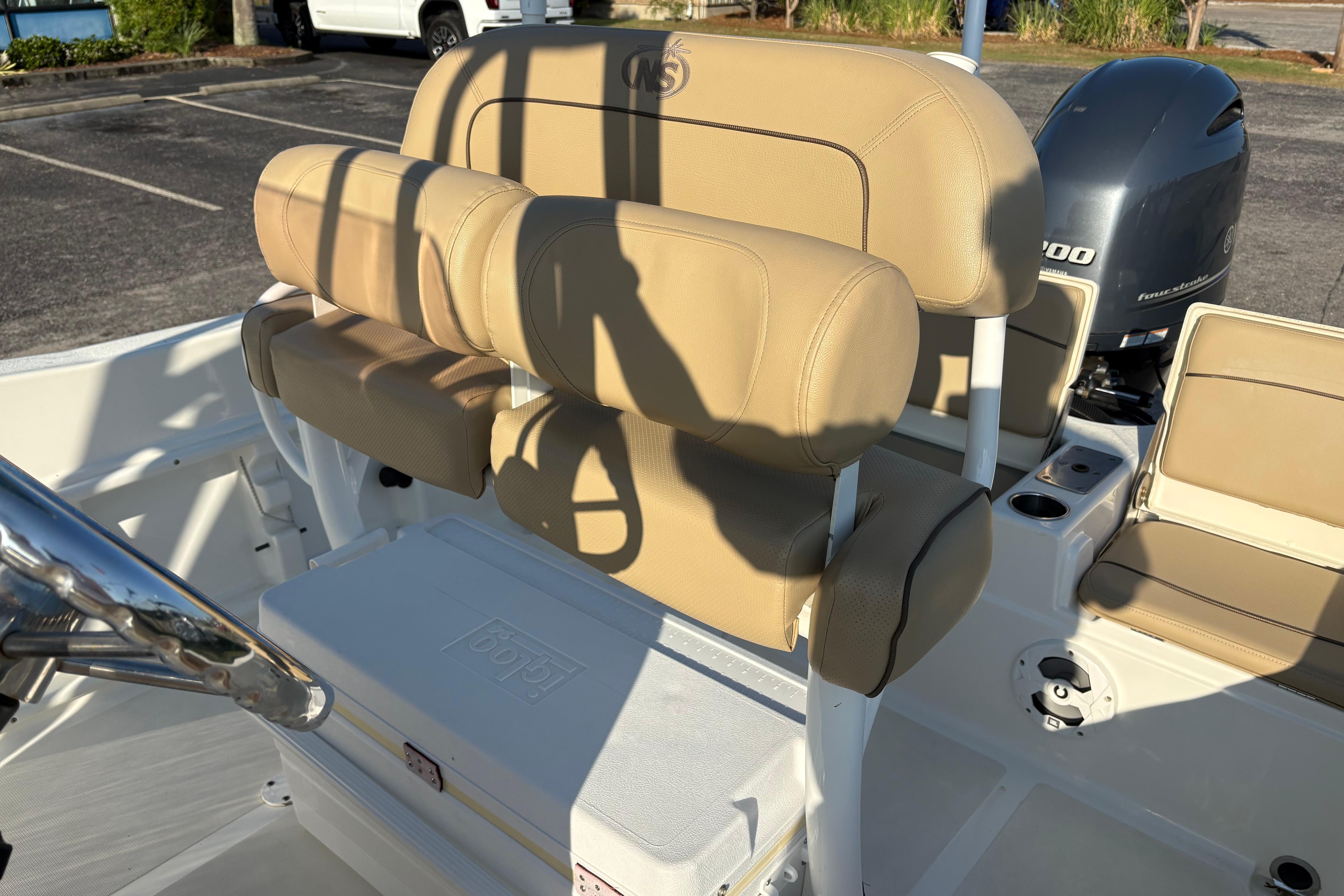 2019 NauticStar 231 Hybrid boat interior with tan seating and Yamaha outboard motor.