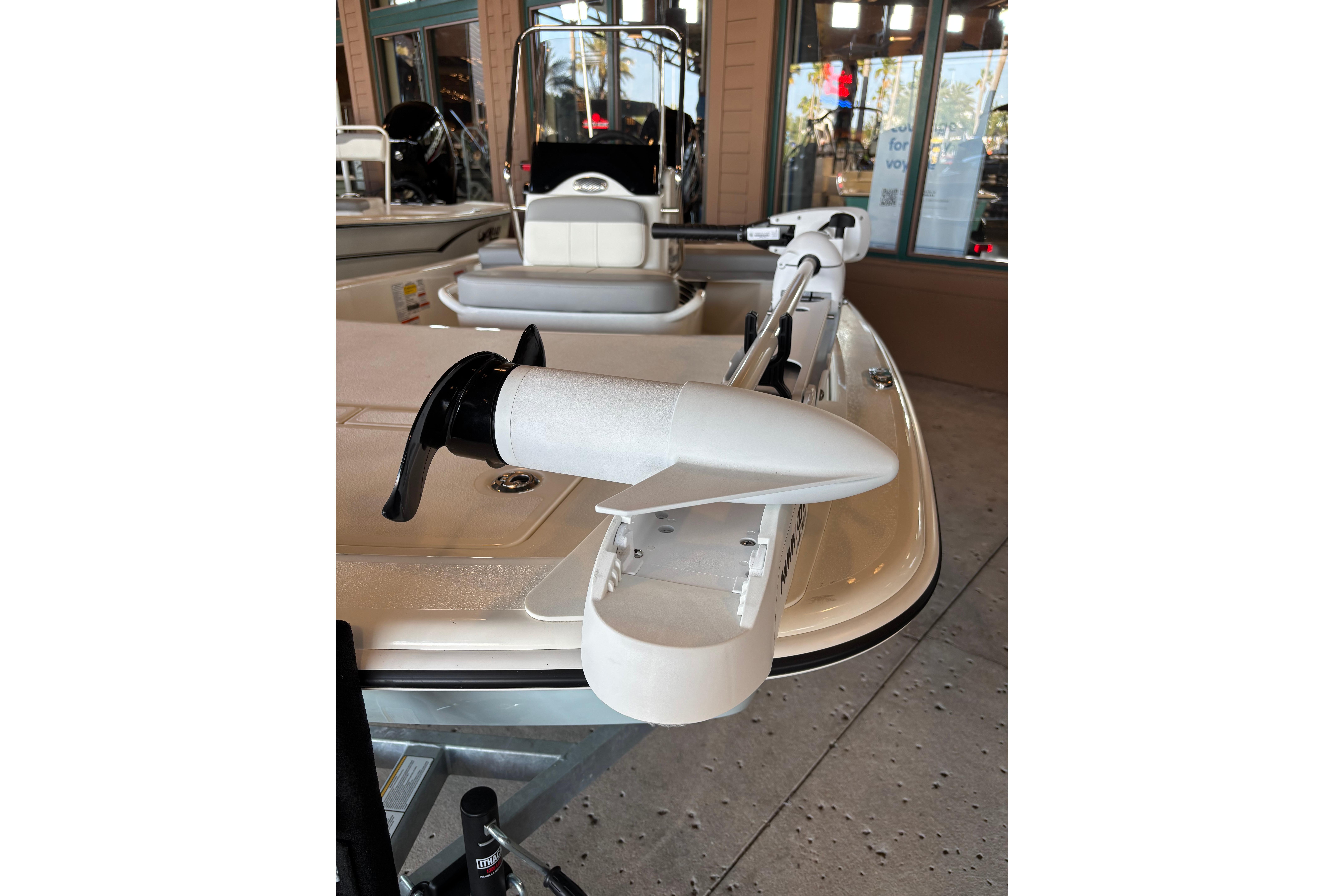 2026 Mako Pro Skiff 13 CC boat with trolling motor in showroom.