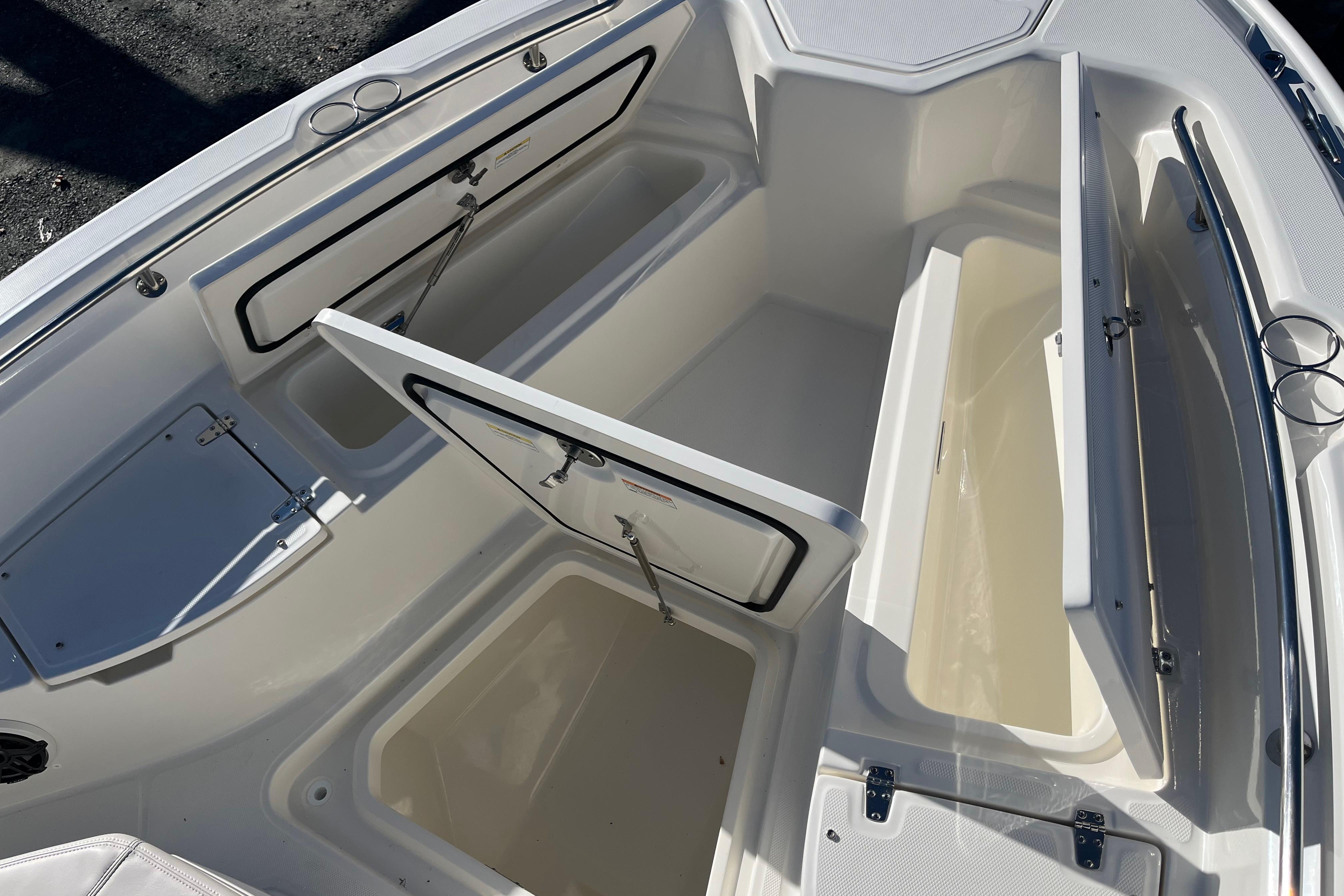 2026 Boston Whaler 280 Dauntless boat storage compartments open, showcasing spacious interior design.