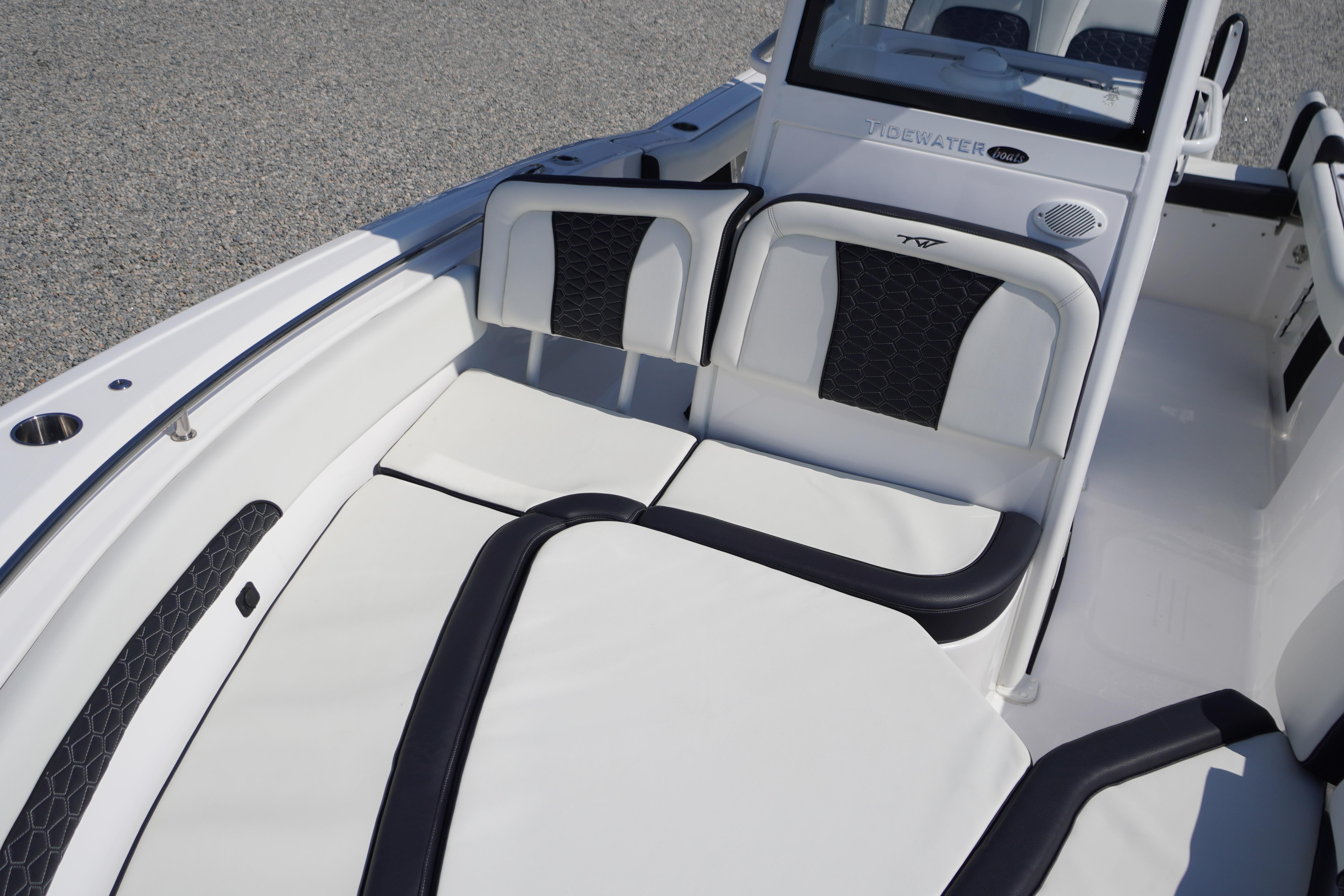 2025 Tidewater 232 SS boat interior with white cushioned seating and sleek design.