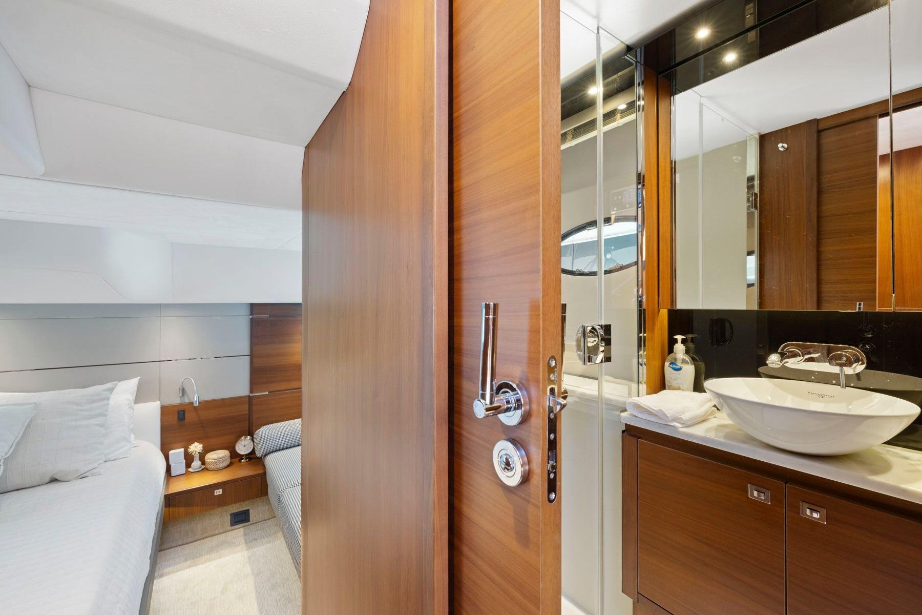 Luxurious interior of 2015 Princess 60 Flybridge Motor Yacht with modern bathroom and cozy bedroom.