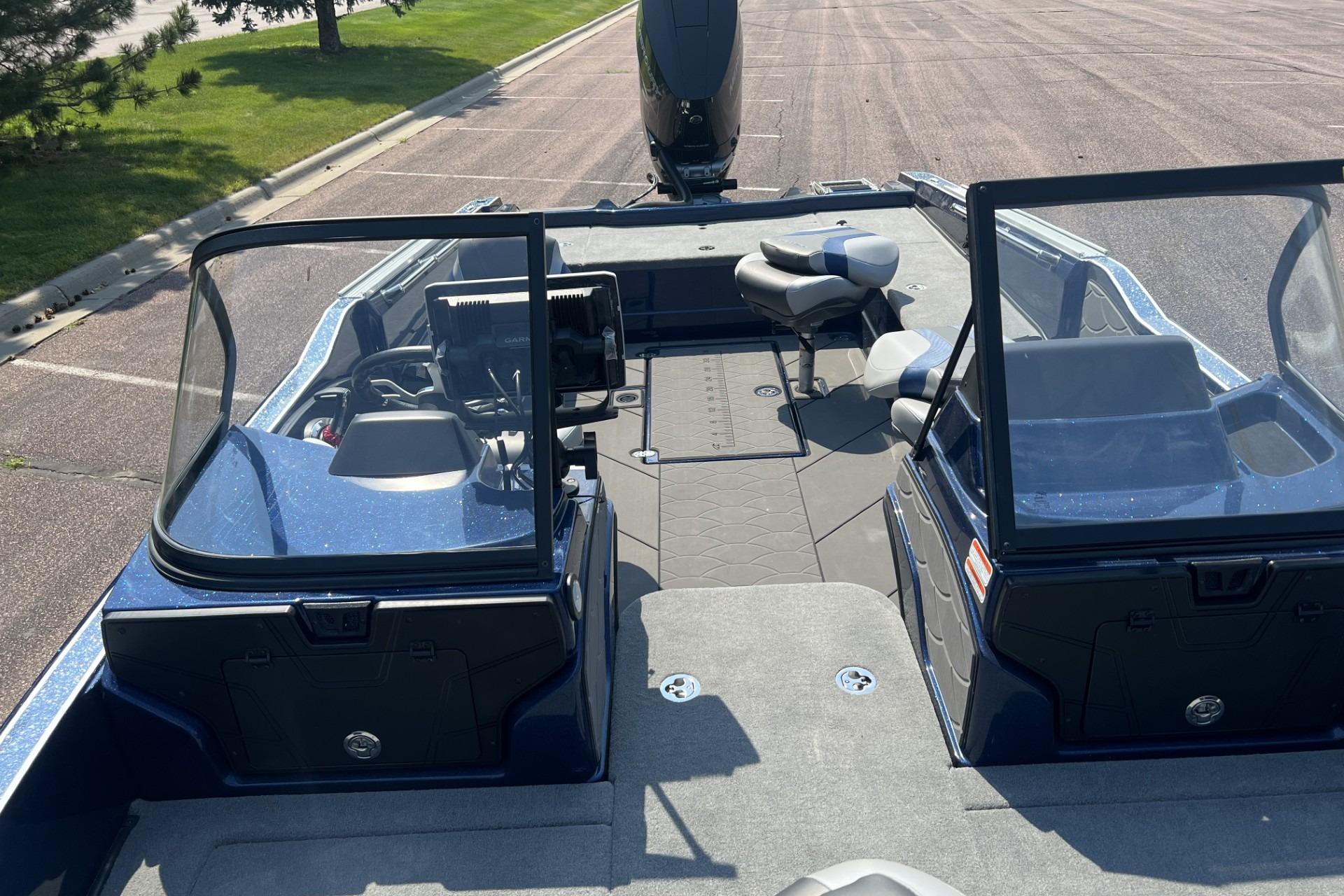 2026 Nitro ZV21 Pro boat interior with dual consoles and seating, parked on pavement.