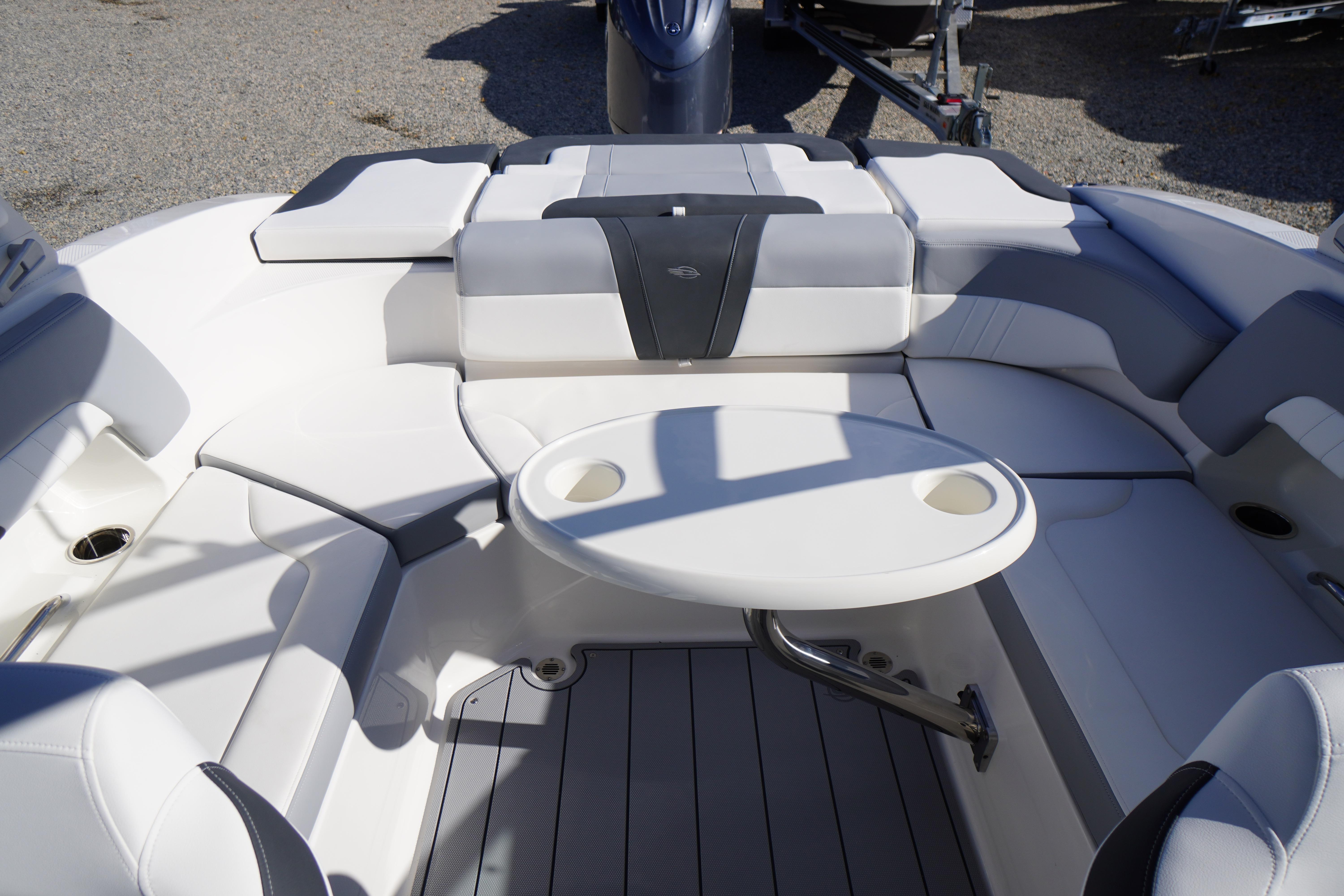 2026 Chaparral 23 SSi OB boat interior with seating and table, showcasing luxury design.