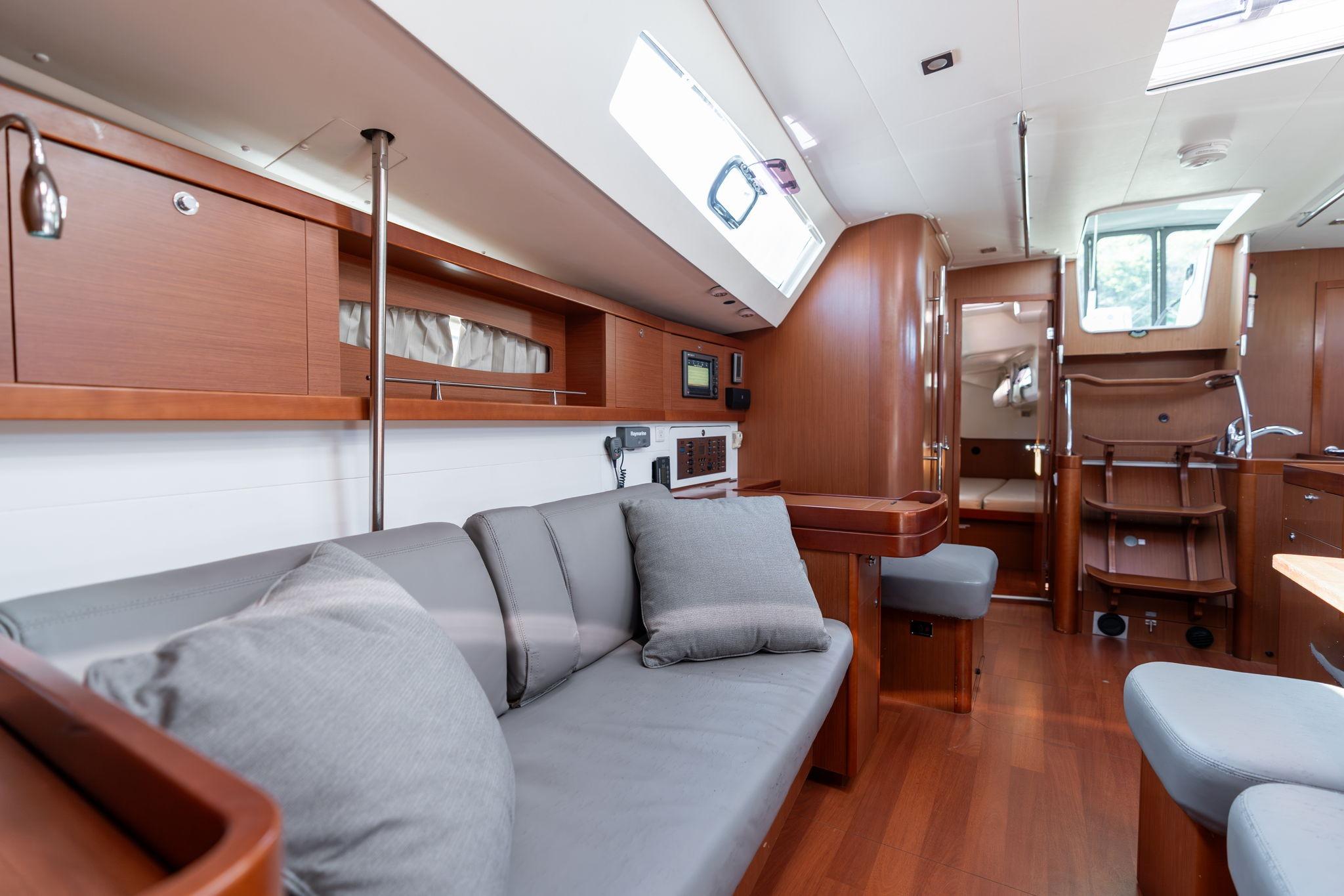 Luxurious interior of 2013 Beneteau Oceanis 50 yacht with modern furnishings and wood finish.