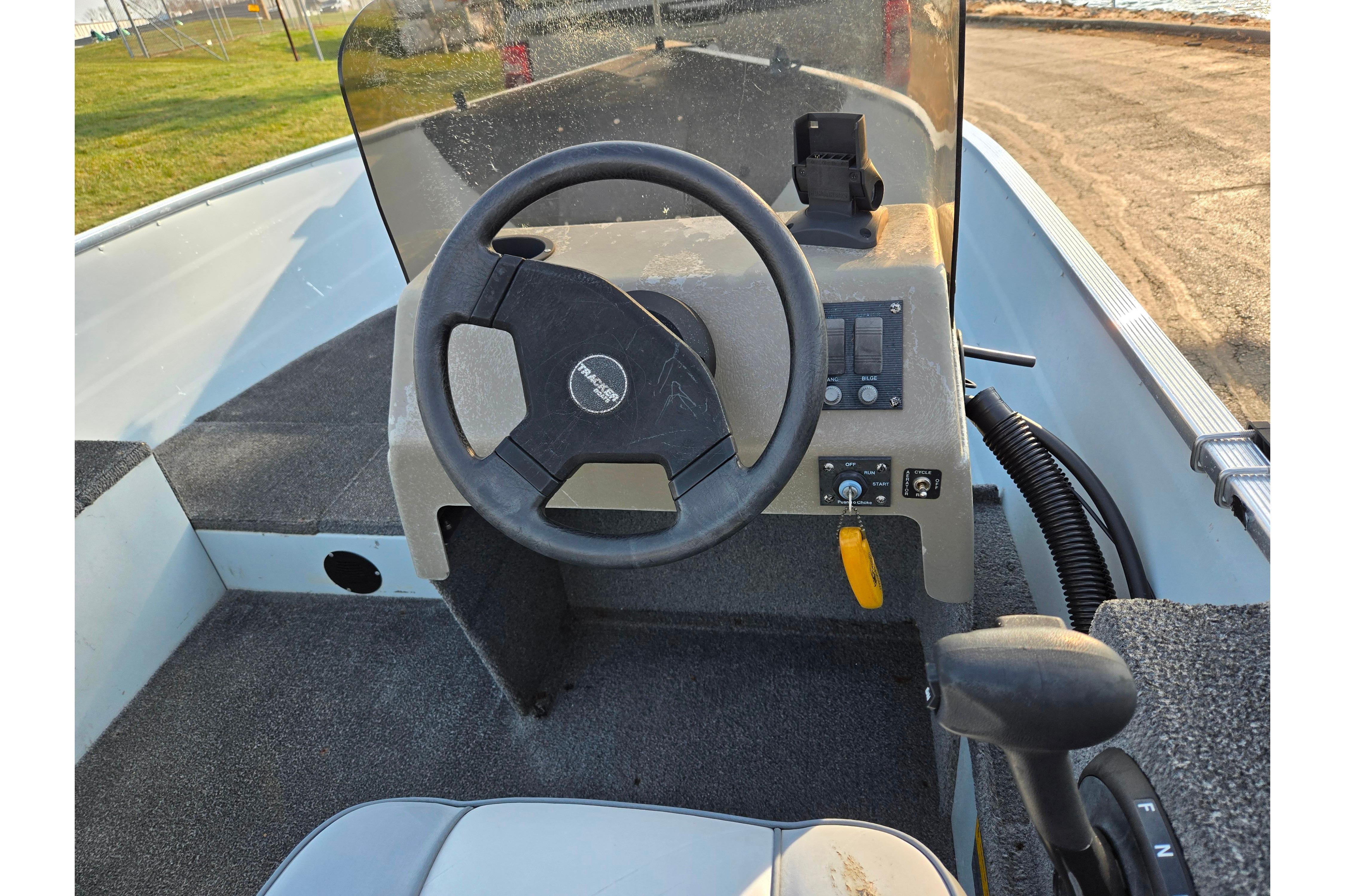 1994 Tracker Pro Deep V-16 boat dashboard with steering wheel and controls.