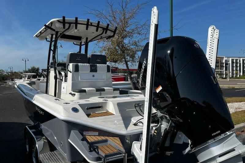 2026 Ranger 2600 Bay boat with powerful outboard motor, parked outdoors.