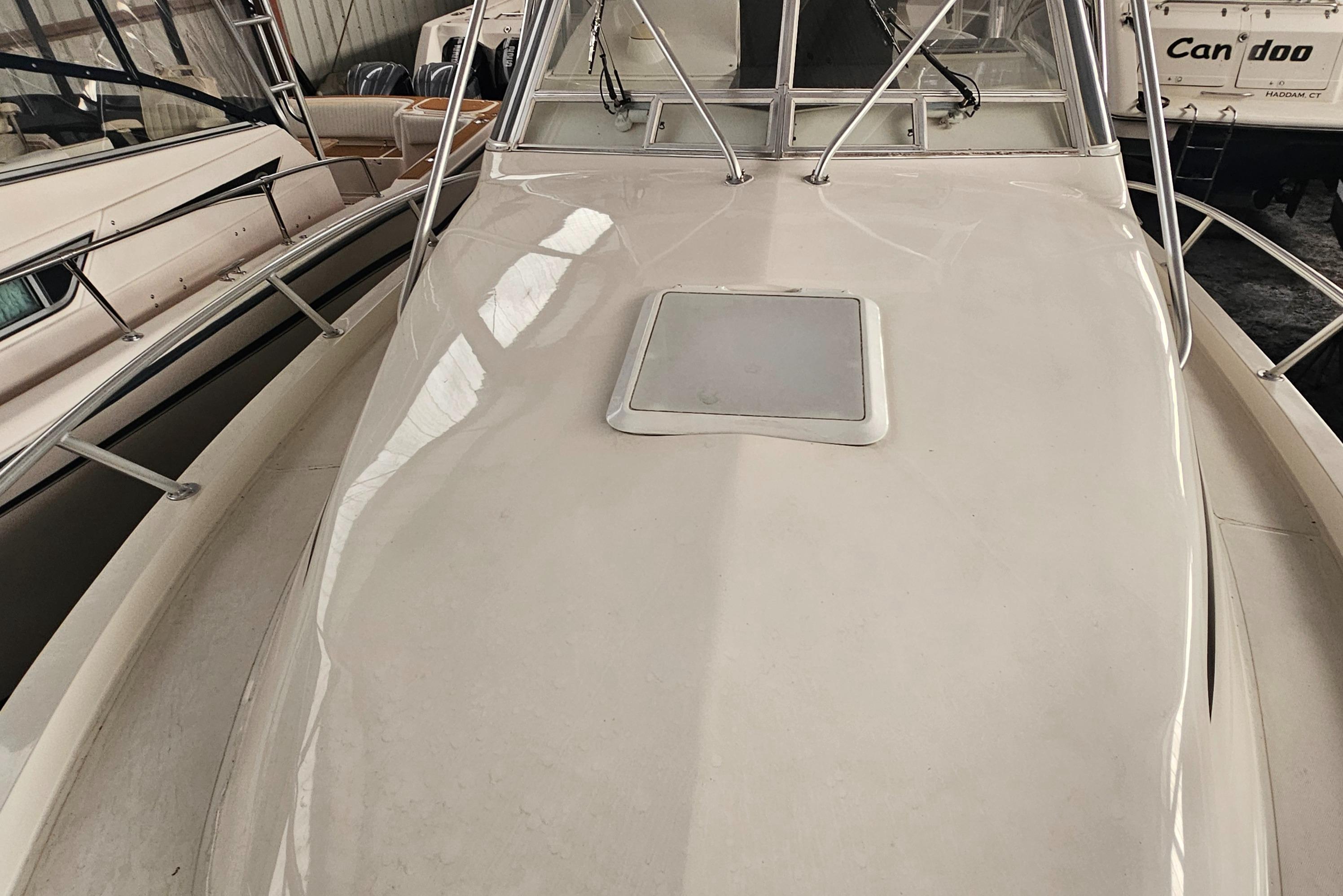 1994 Blackfin 33 Combi boat deck with hatch, docked indoors.