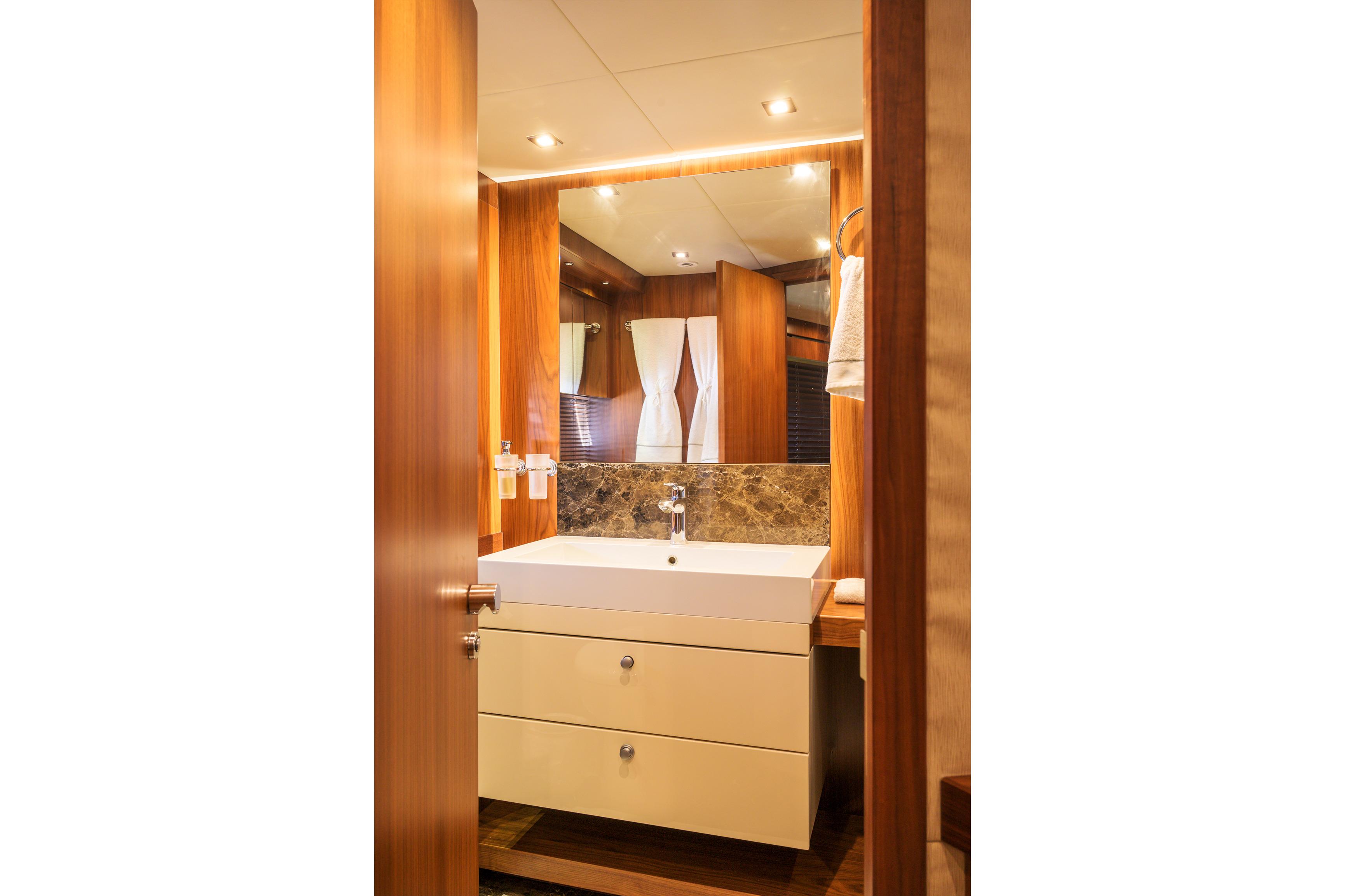 Luxurious bathroom interior on 2015 Sunseeker 28 Metre Yacht, featuring modern sink and wood accents.