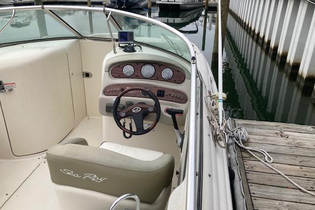 2006 Sea Ray 270 Sundeck boat interior with steering wheel and dashboard at dock.
