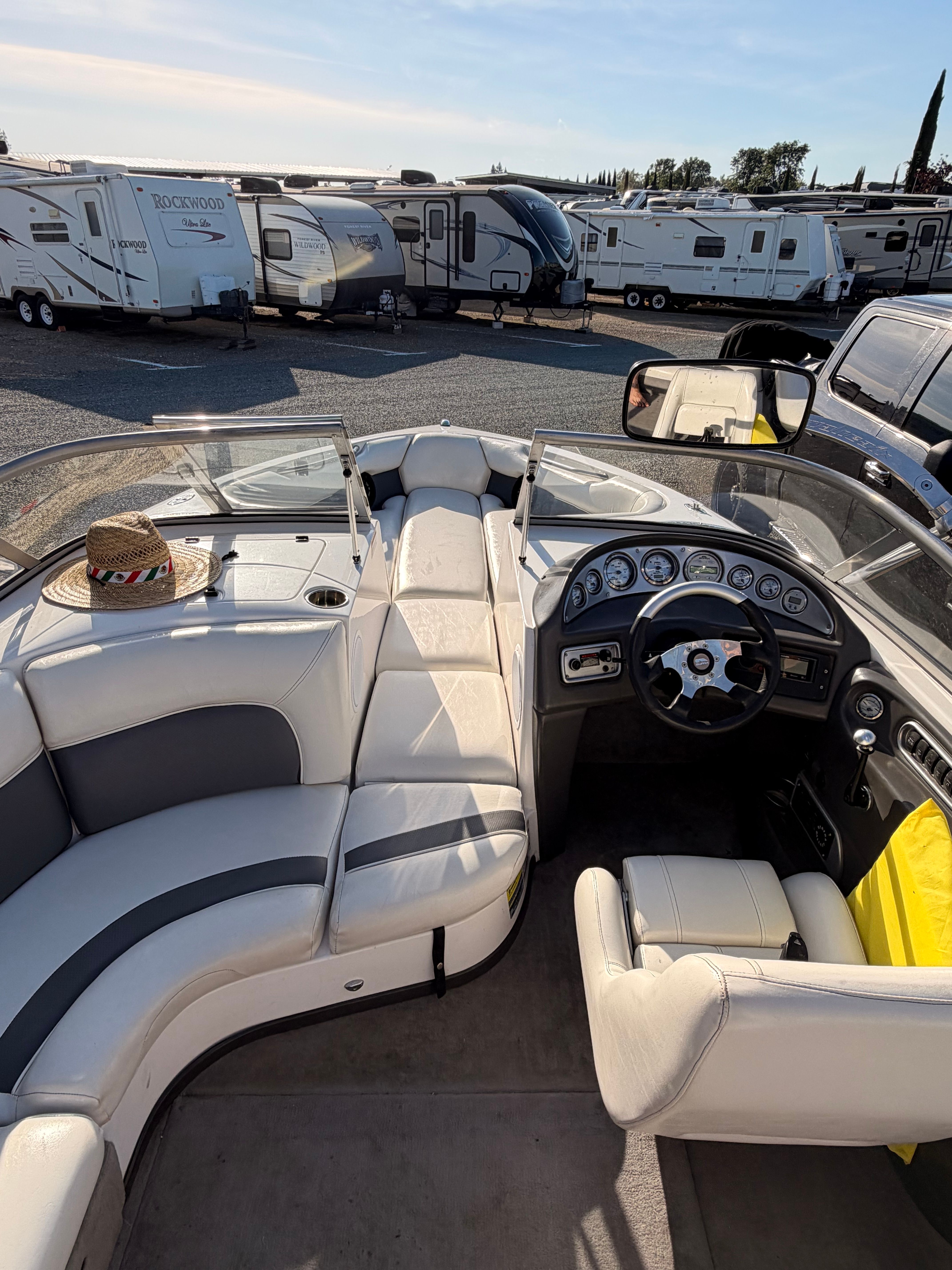 Interior of a 2004 Supra Launch SSV boat with RVs in the background.