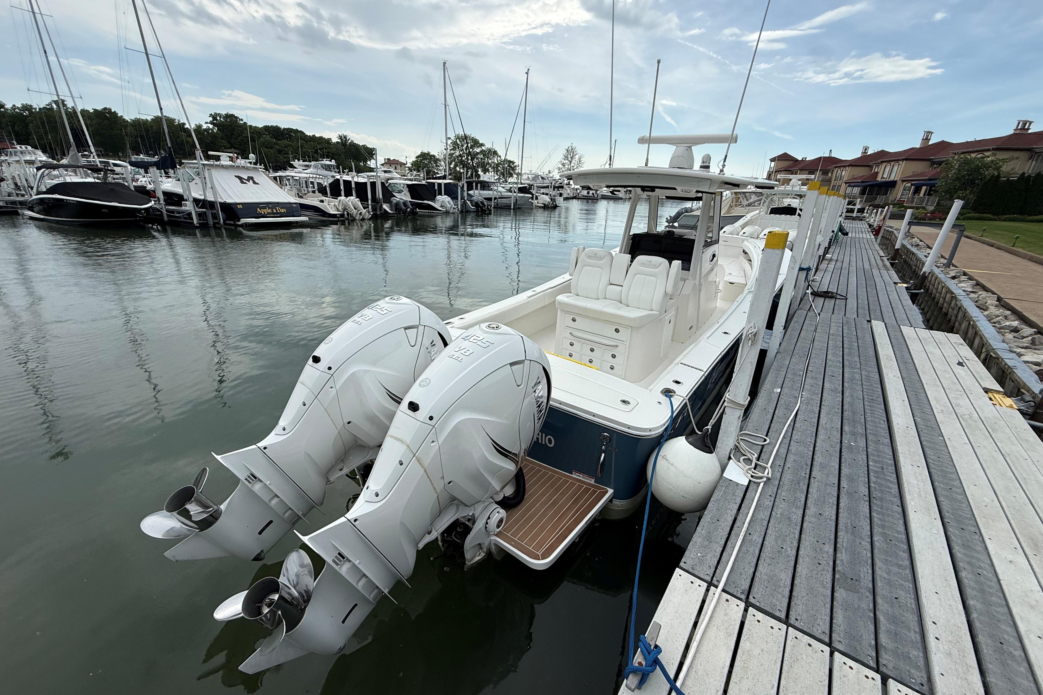2021 Regulator 31 boat docked with twin outboard engines in a marina setting.