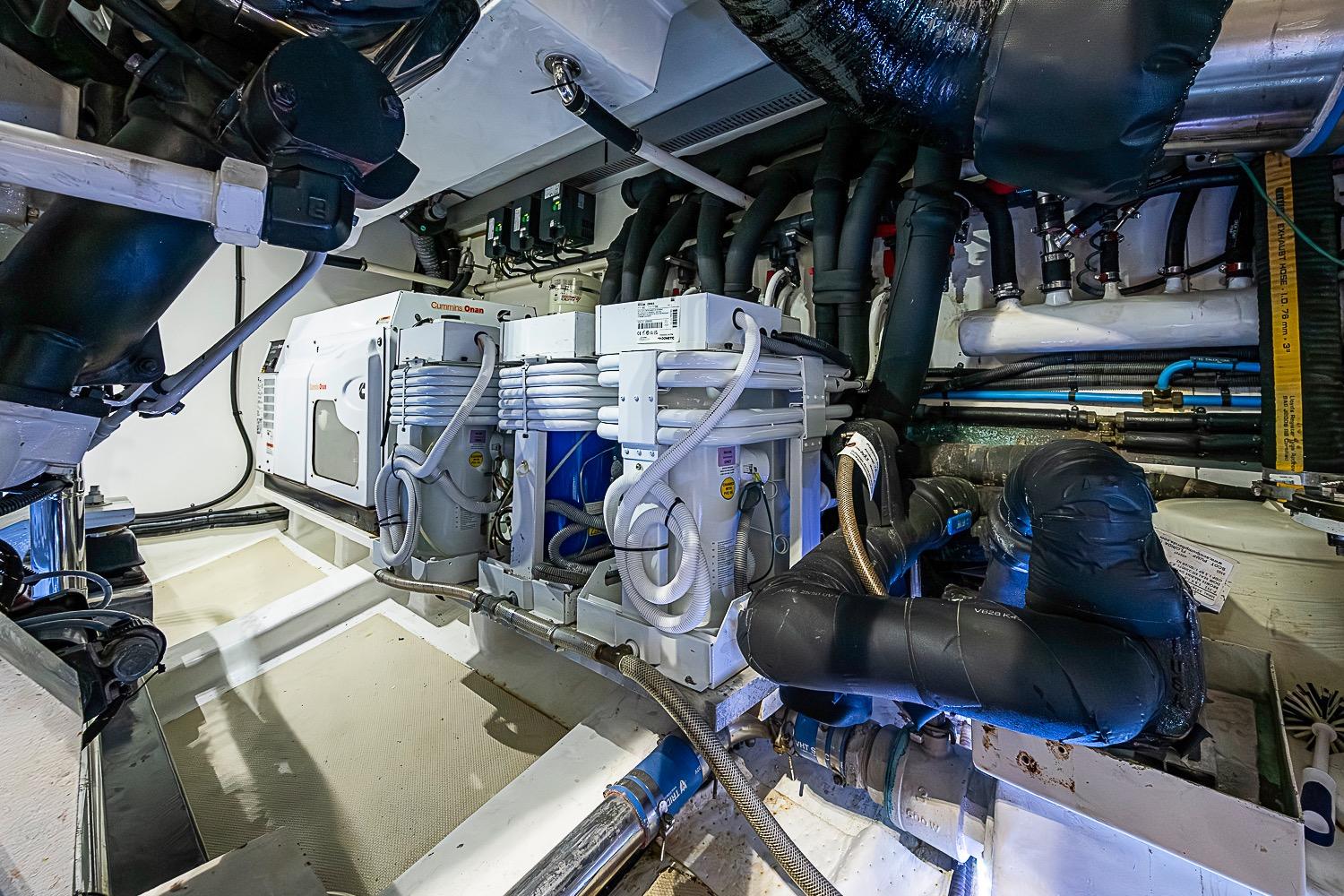 Engine room of 2014 Marlow 80 Explorer yacht with complex piping and machinery.