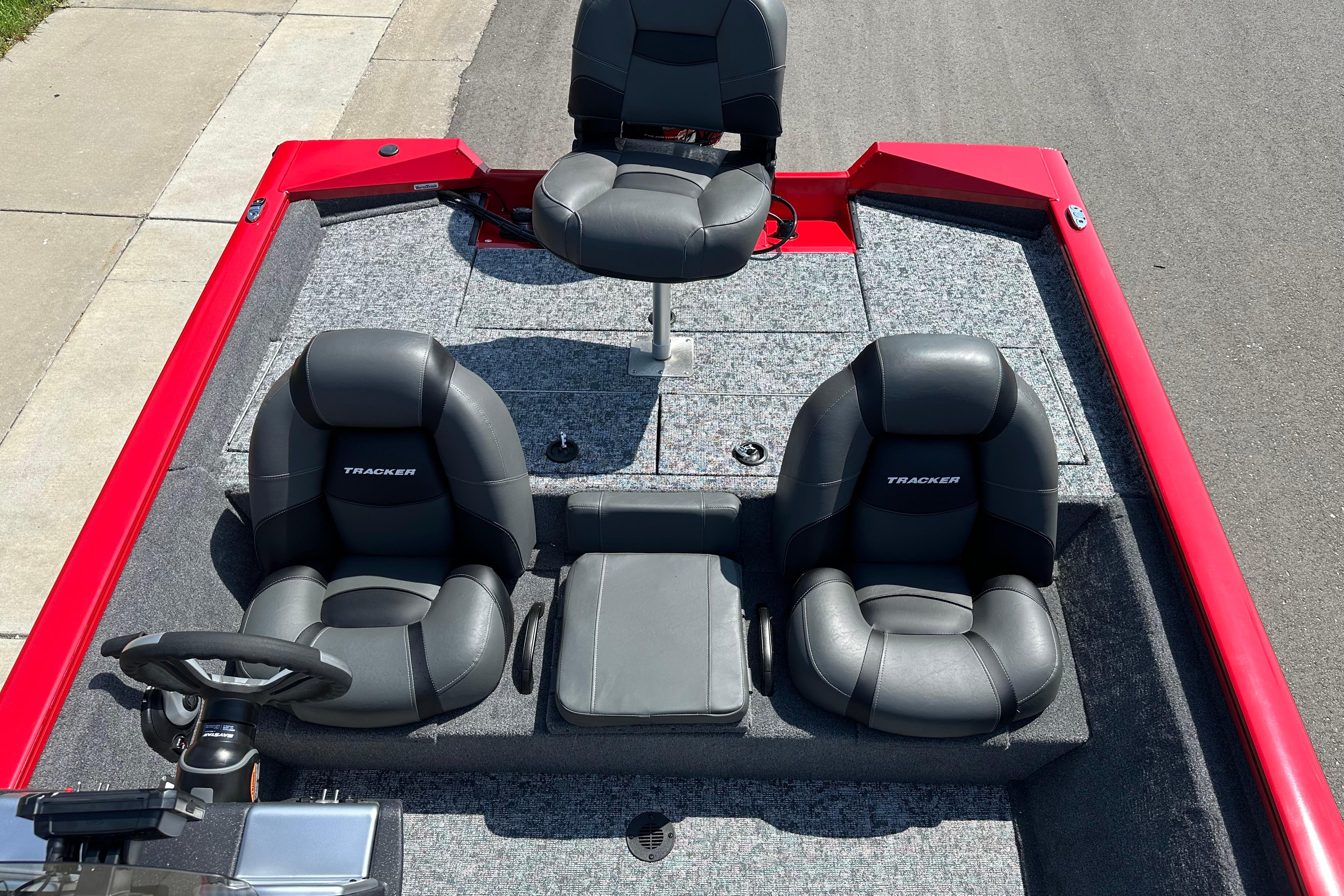2026 Tracker Pro Team 195 boat interior with three black seats and red accents.